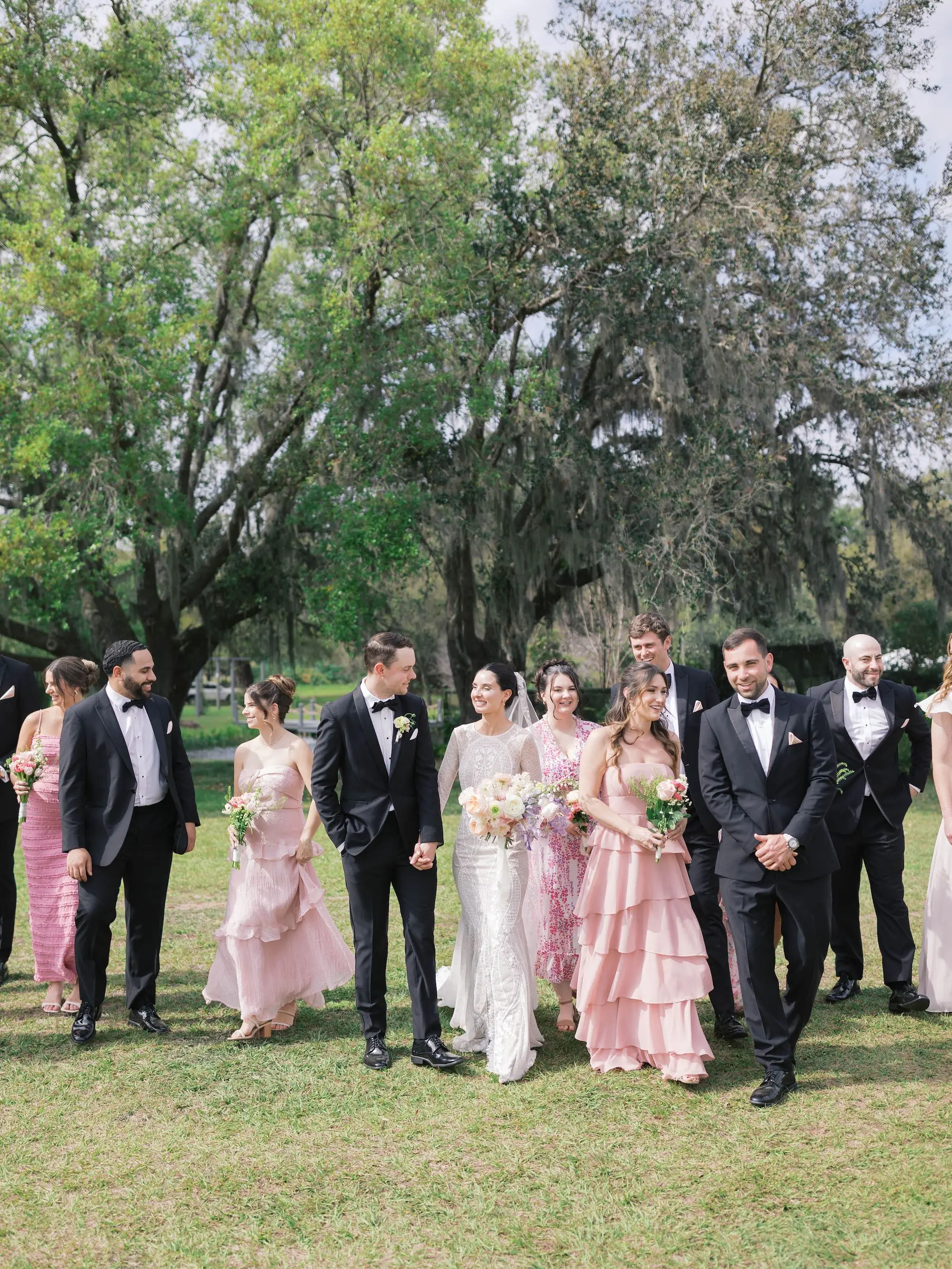 Bride and Groom with Garden Wedding Party Attire Inspiration | Groomsmen in Black Tuxedo | Mismatched Pink Bridesmaids Dress Ideas