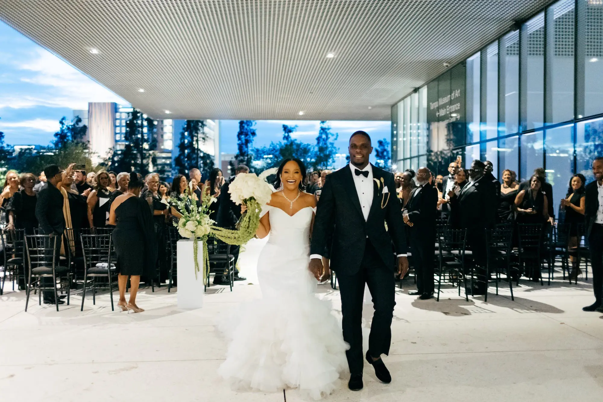 Bride and Groom Just Married Wedding Ceremony Portrait | Elegant Modern Black Tie Night Museum Wedding Ceremony Inspiration | Monochromatic White Floral Bridal Bouquet with Long Green Stem Ideas | Wedding Venue Tampa Museum of Art | Tampa Bay Event Planner Unique Weddings and Events