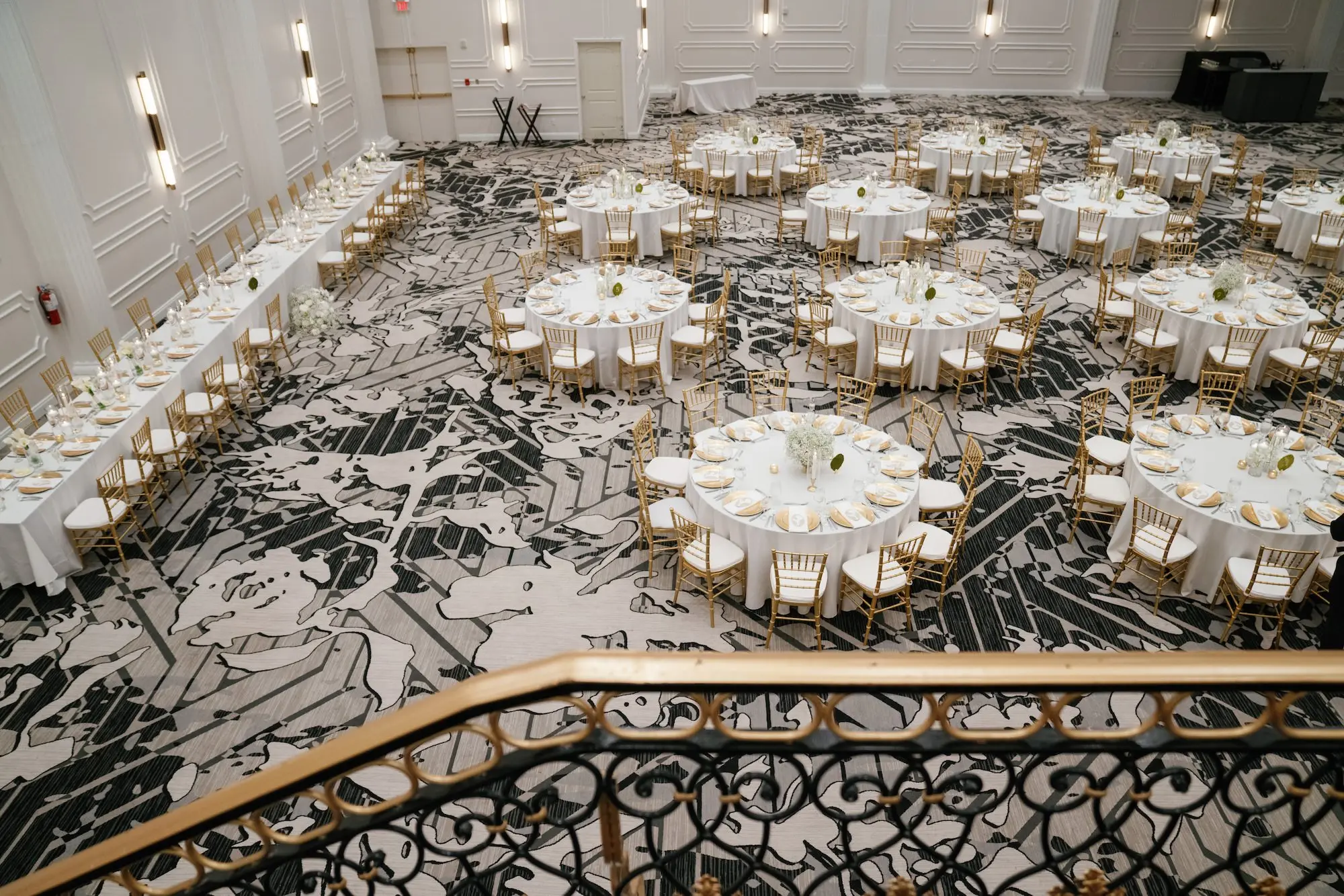 Elegant Ballroom White and Gold Wedding Reception Inspiration | Gold Chiavari Chairs at Round Tables with White Linens Decor Ideas | Gold Chargers with White Napkins and Romantic White Floral Centerpieces with Tea Candles Decor Inspiration | Historic Tampa Venue Hotel Flor