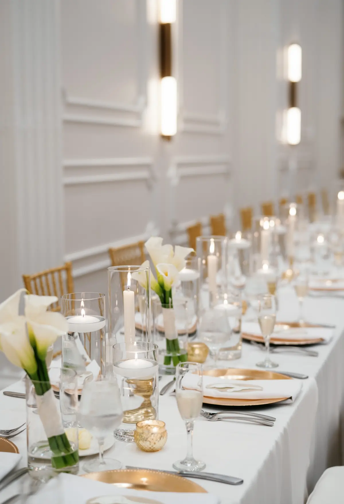Elegant Ballroom White and Gold Wedding Reception Inspiration | Gold Chargers with White Napkins and Romantic White Tape Candles Decor Tablescape Ideas | White Lilies Bouquet Floral Centerpieces Inspiration | Historic Tampa Venue Hotel Flor