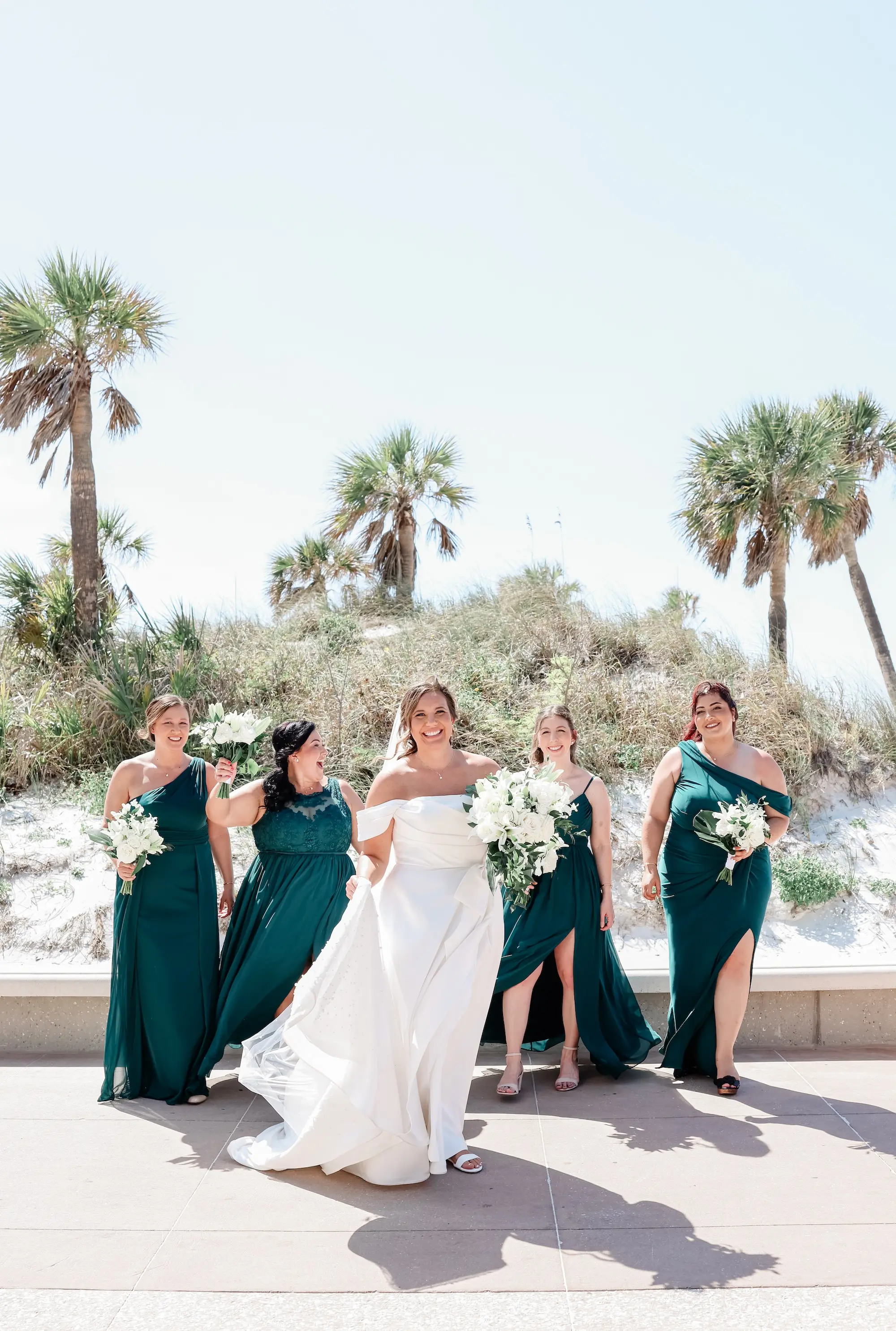 Bride and Bridesmaid Outdoor Beach Wedding Portrait | Mismatched Styles Dark Green Azazie Bridesmaid Dresses Inspiration | White Florals with Greenery Bridal Bouquets Ideas | Tampa Bay Florist Save The Date Florida | St Pete Photographer Lifelong Photography Studio
