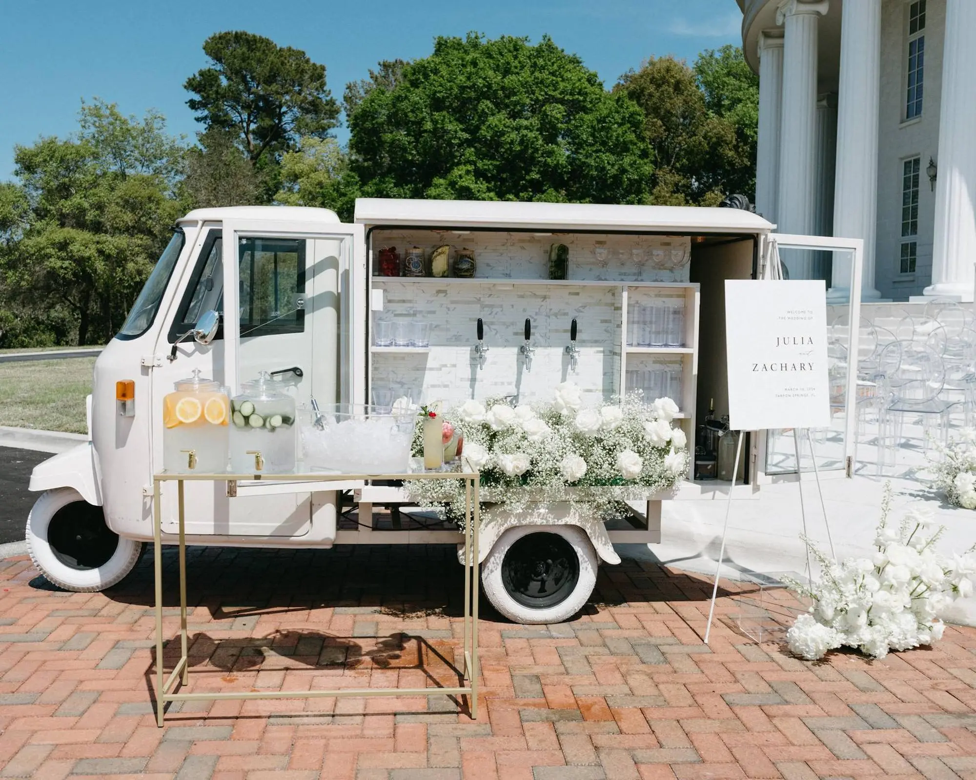 Modern Vintage White Wedding Mobile Bar Inspiration | Monochromatic White Roses and Baby's Breath Floral Arrangement Wedding Ceremony Decor Ideas