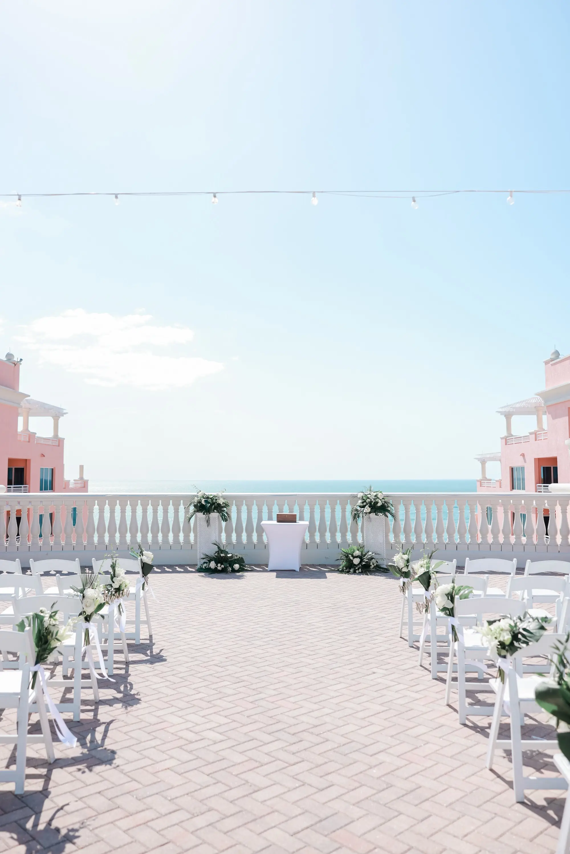 White Chairs for Intimate Rooftop Clearwater Beach Florida Wedding Ceremony Inspiration | White and Green Wedding Ceremony Aisle Altar Aisle Decor Ideas | Tampa Bay Florist Save The Date Florida | Waterfront Wedding Venue Hyatt Regency Clearwater Beach