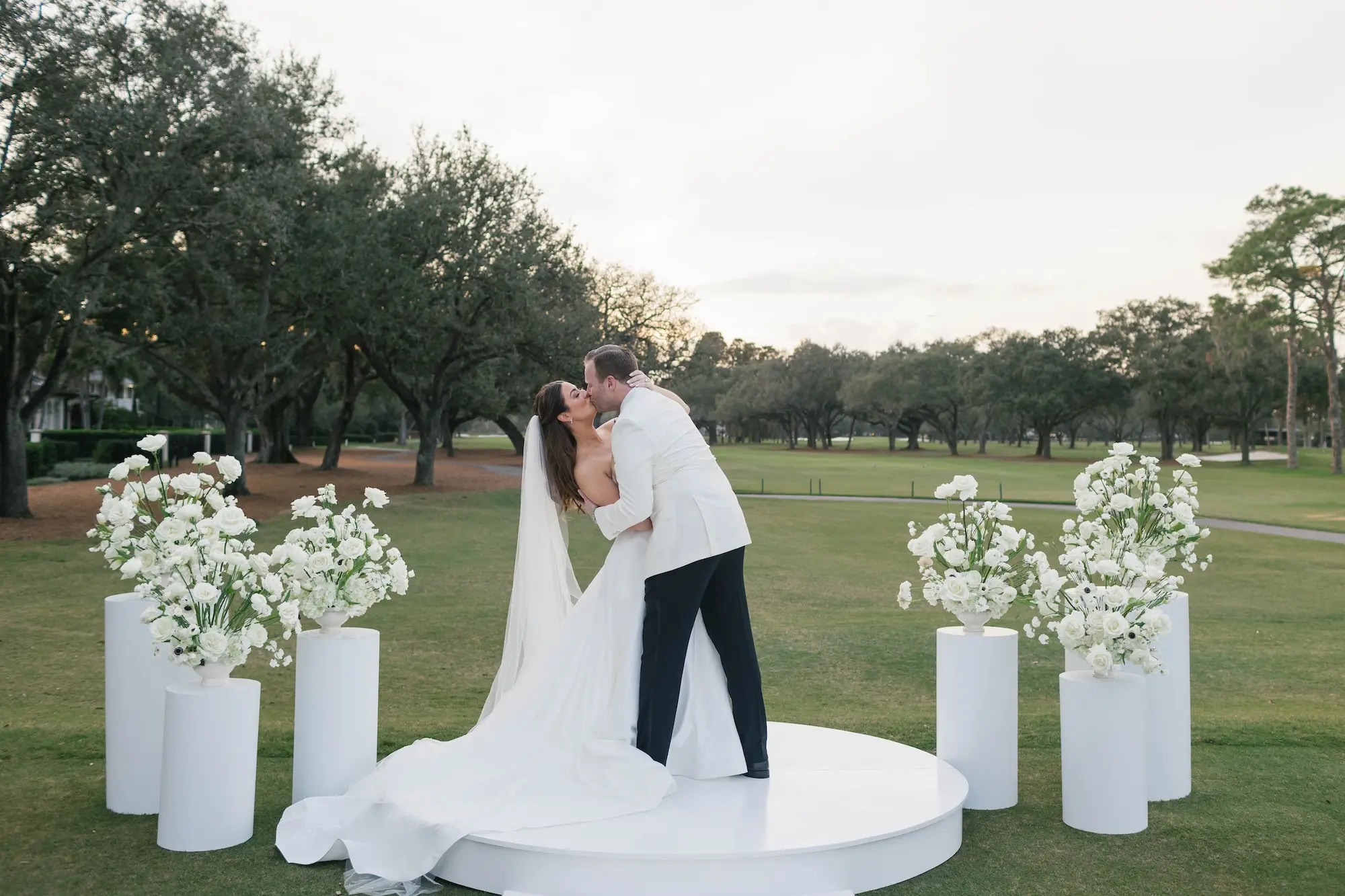 Bride and Groom First Kiss Wedding Portrait | Romantic, Modern, Luxurious White Wedding Ceremony Decor Inspiration | Tampa Bay Event Venue Palma Ceia Golf and Country Club