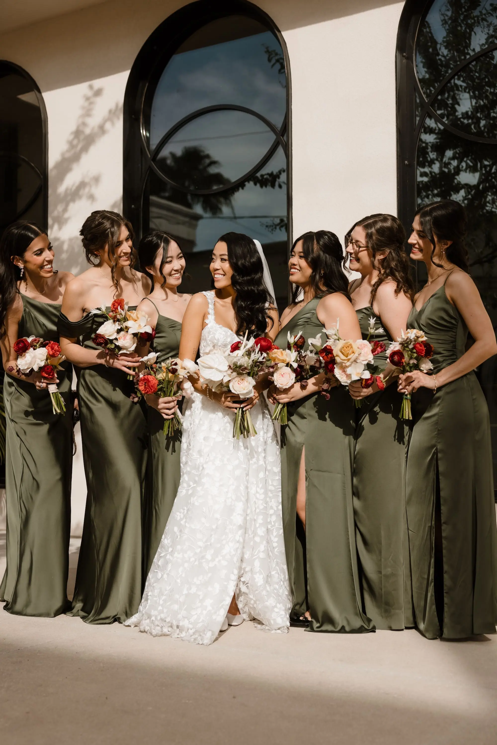 23Modern Romantic Wedding Inspiration - Modern, Moody Fall Ybor City Wedding | Hotel Haya Bride and Bridesmaids Wedding Portrait | Mismatched Olive Green Satin Bridesmaid Dresses Inspiration | White, Cream, Crimson Wedding Bouquet Ideas | Tampa Bay Photographer Evoke Photo and Film