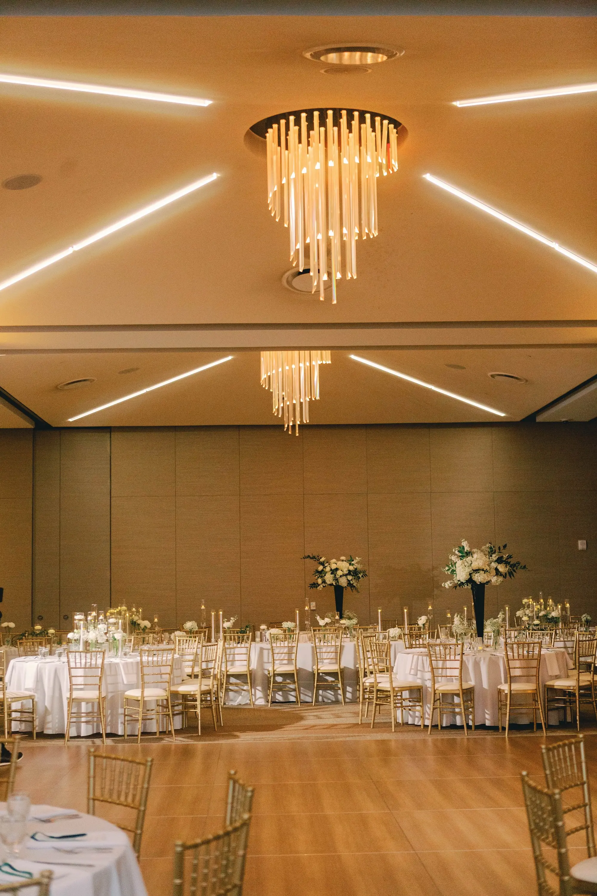 29Classic White and Green Wedding Ideas St Pete Venue The James Musuem - Classic, White and Green St. Pete Wedding | The James Museum of Western & Wildlife Art Timeless Black and White Museum Ballroom Wedding Reception | White Linens and Gold Chiavari Chairs | Tall Dark Green Vases with White Roses, Wisteria Florals in Greenery Arrangements Centerpiece Decor Inspiration | Floating Tea Candles Table Decor Ideas | St. Pete Wedding Venue The James Museum | Kate Ryan Event Rentals