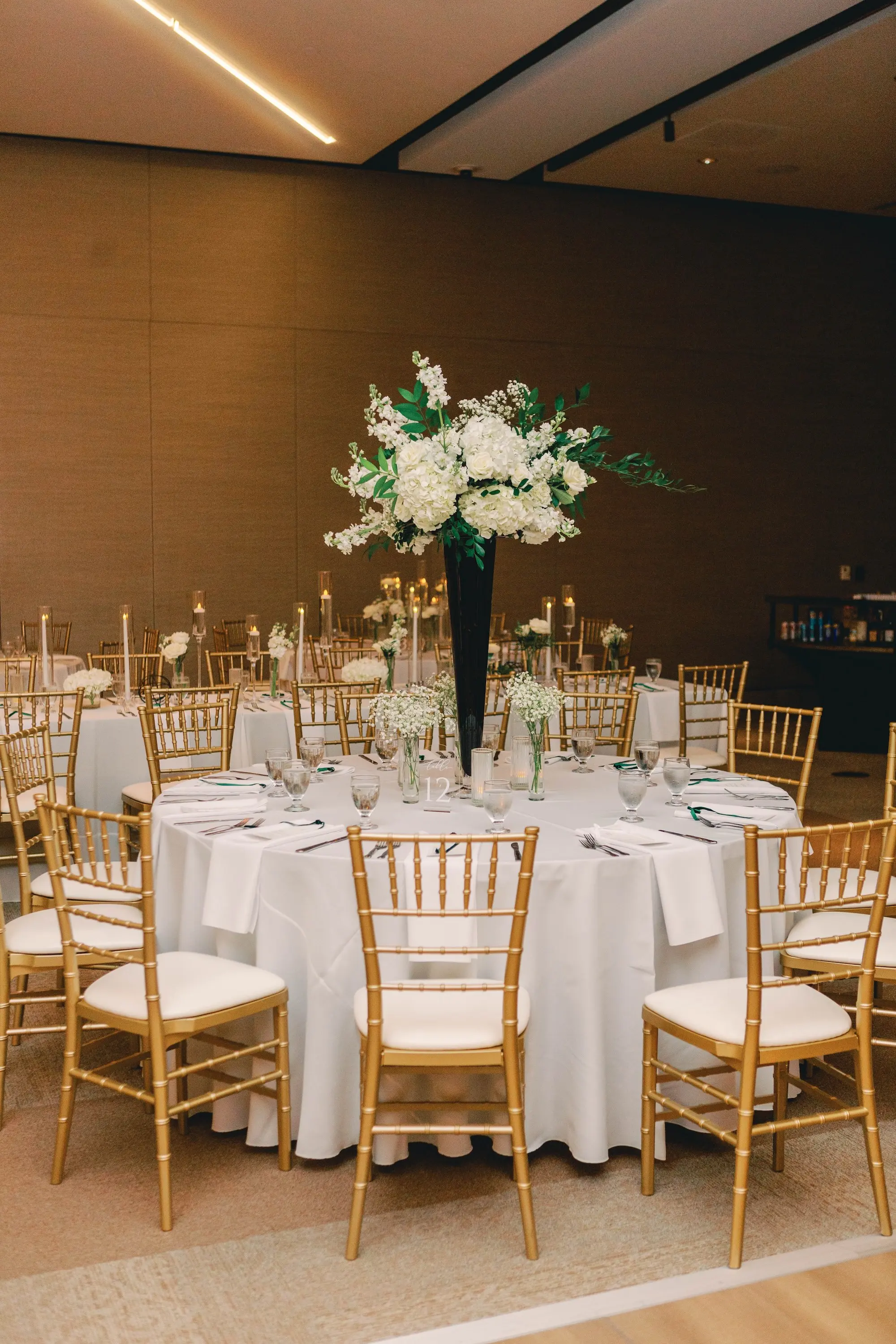 30Classic White and Green Wedding Ideas - Classic, White and Green St. Pete Wedding | The James Museum of Western & Wildlife Art Timeless Black and White Museum Ballroom Wedding Reception | White Linens and Gold Chiavari Chairs | Tall Dark Green Vases with White Roses, Wisteria Florals in Greenery Arrangements Centerpiece Decor Inspiration | Floating Tea Candles Table Decor Ideas | St. Pete Wedding Venue The James Museum | Kate Ryan Event Rentals