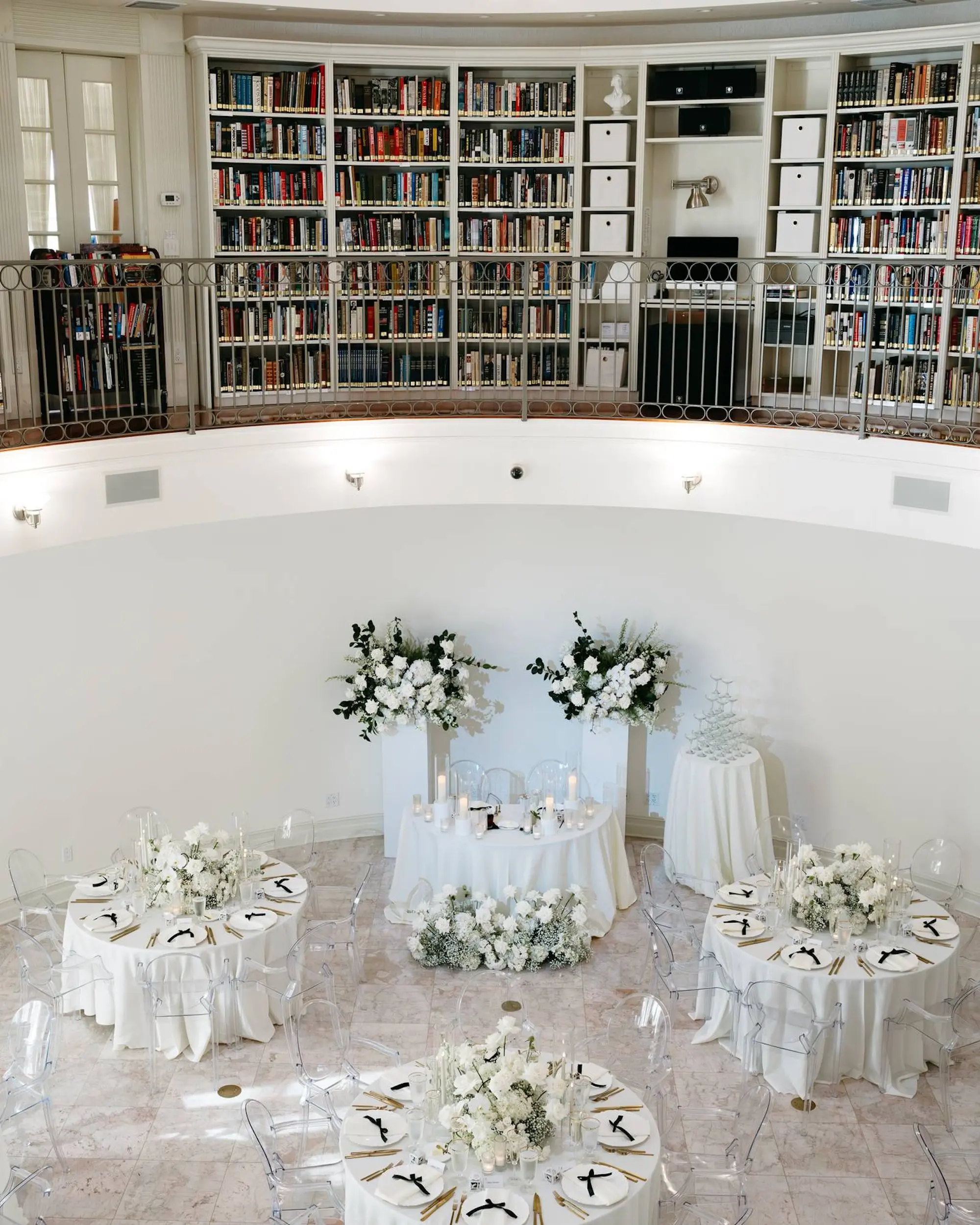 Minimalist Monochromatic White Wedding Reception Decor Ideas | Monochromatic White Flower Centerpiece Inspiration | Modern Ghost Chairs and White Linens Decor Ideas | Neoclassical Architectural Tarpon Springs Wedding Venue Whitehurst Gallery