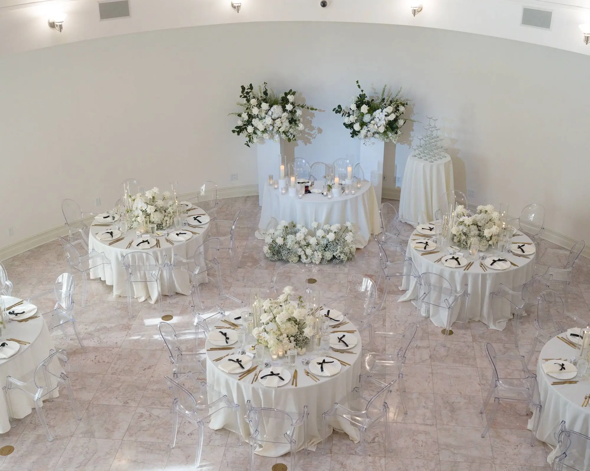 Minimalist Monochromatic White Wedding Reception Decor Ideas | Monochromatic White Flower Centerpiece Inspiration | Modern Ghost Chairs and White Linens Decor Ideas | Intimate Wedding Reception Inspiration | Neoclassical Architectural Tarpon Springs Wedding Venue Whitehurst Gallery