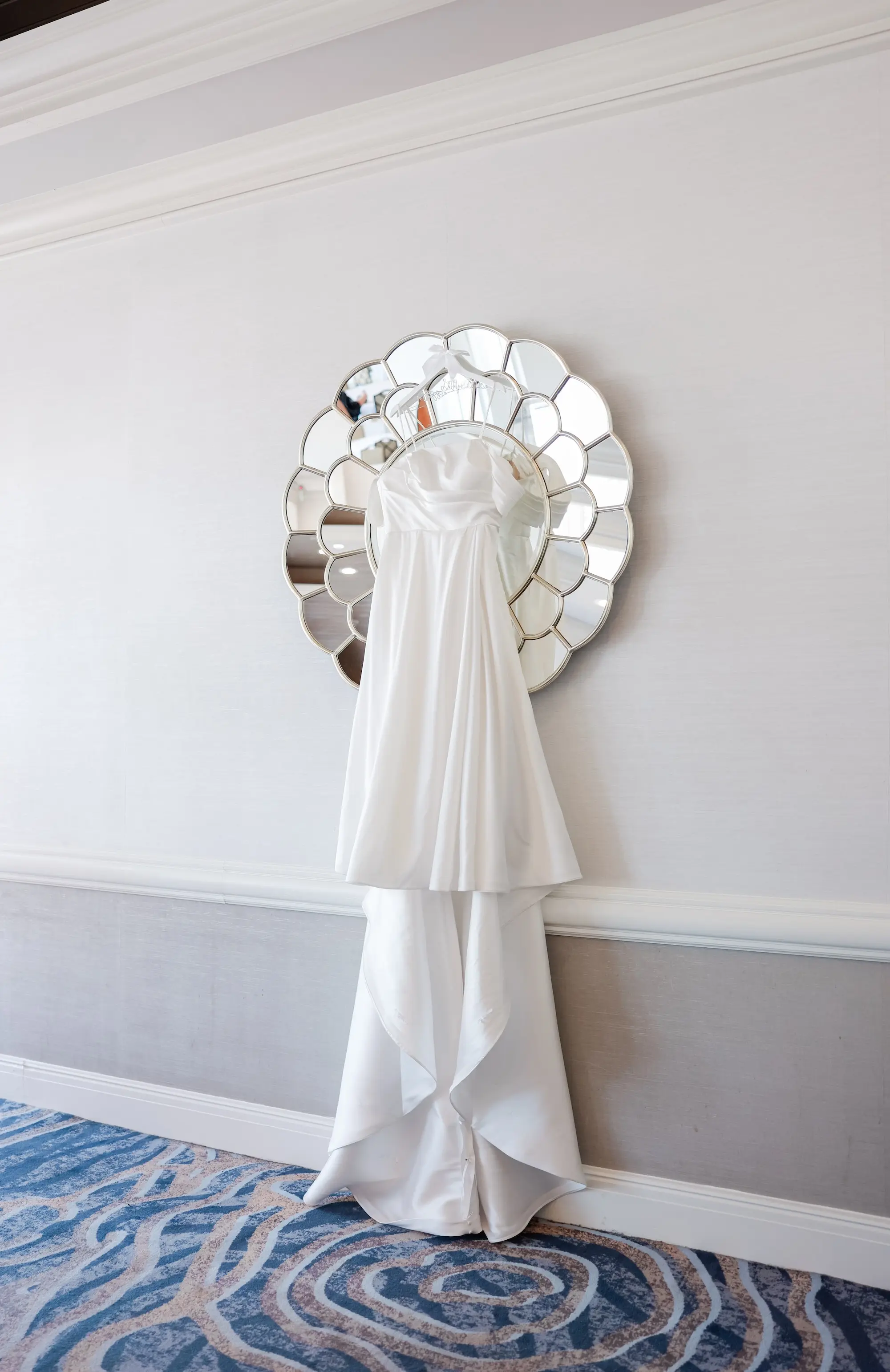 White Strapless, Sweetheart Neckline Wedding Ballgown Hanging in Front of Glass Mirror Inspiration