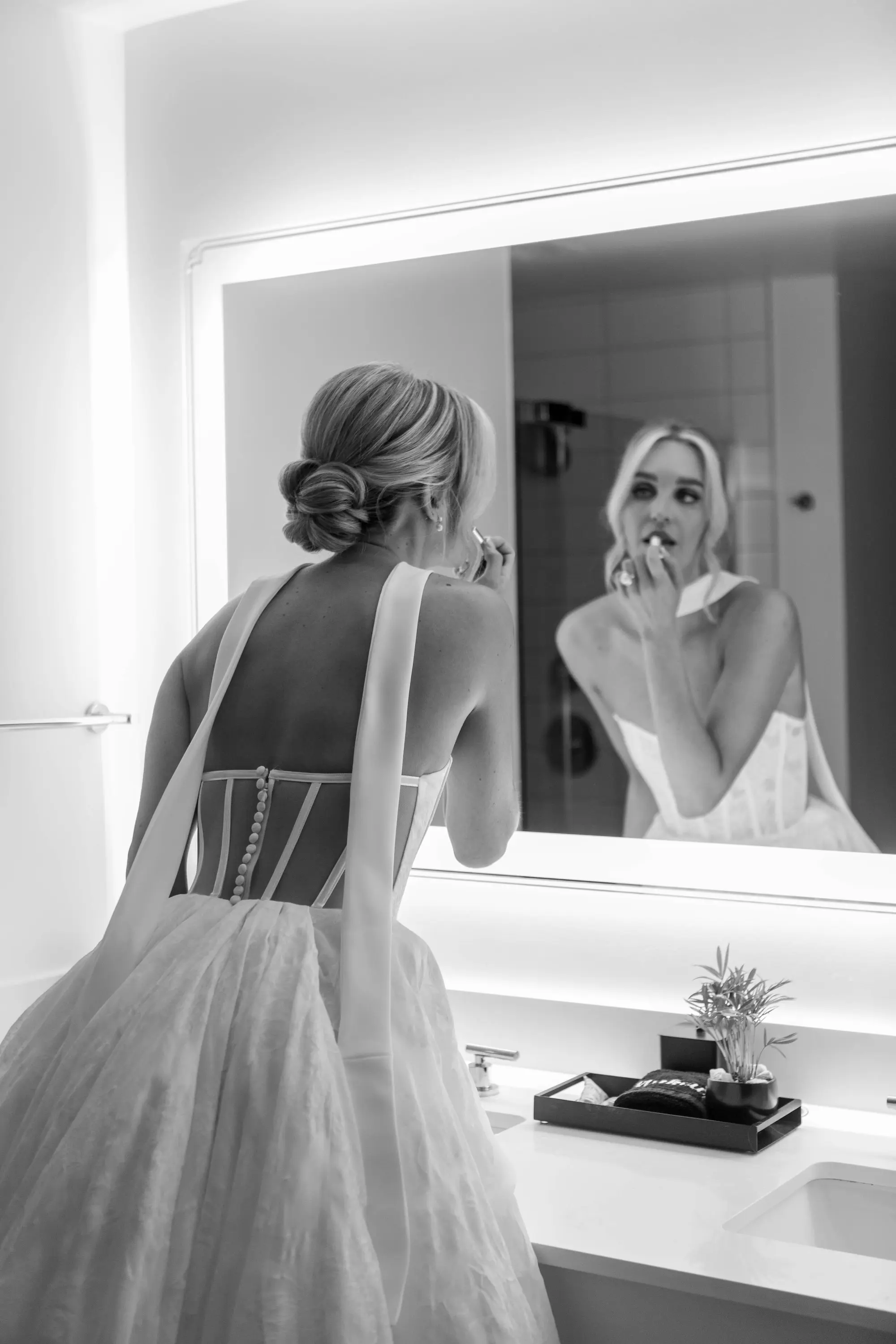 5Classic White and Green Wedding Ideas - Classic, White and Green St. Pete Wedding | The James Museum of Western & Wildlife Art Bride Getting Ready Putting Lipstick On Black and White Wedding Portrait