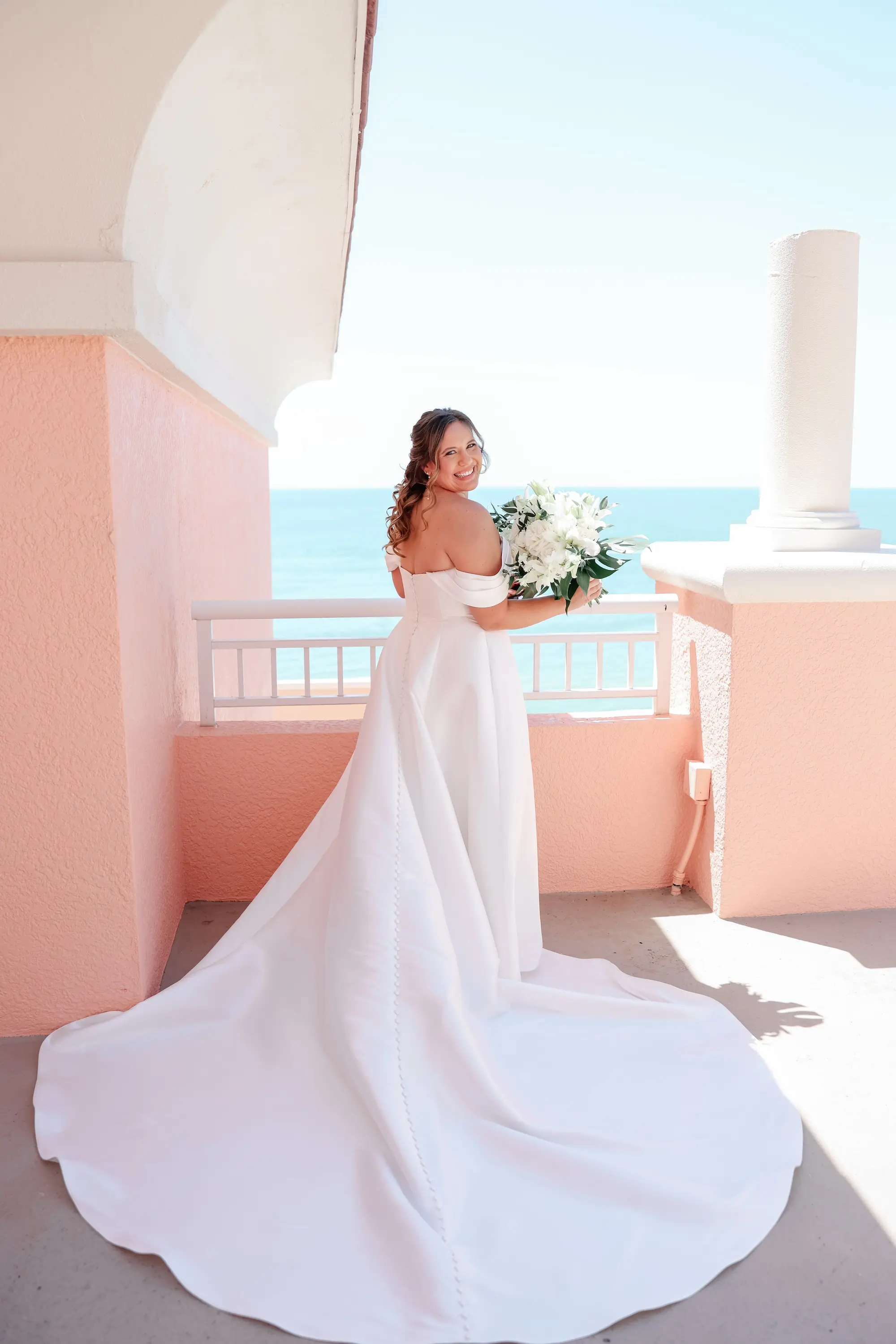 Bride Balcony Waterfront Wedding Portrait | White Orchids, Roses, Lilies with Green Palm Fronds Bridal Bouquet Inspiration | Tampa Bay Florist Save The Date Florida | St Pete Photographer Lifelong Photography Studio