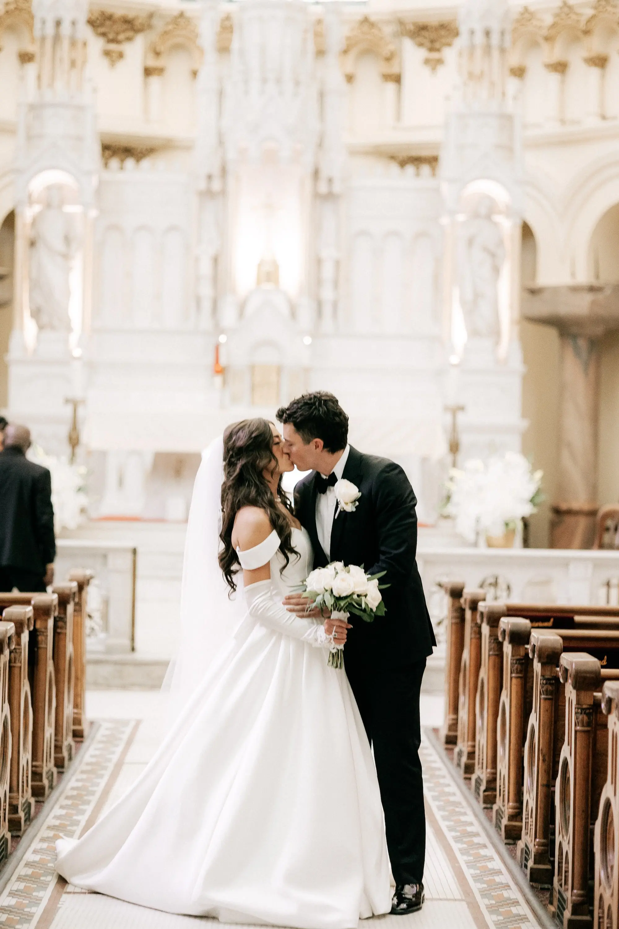 16Classic Gold and White Wedding Decor Inspiration - Classic, Ivory Rooftop Wedding | Grand Hyatt Tampa Bay Bride and Groom Kissing in Wedding Ceremony Aisle Wedding Portrait | Sacred Heart Catholic Church Wedding Ceremony Venue
