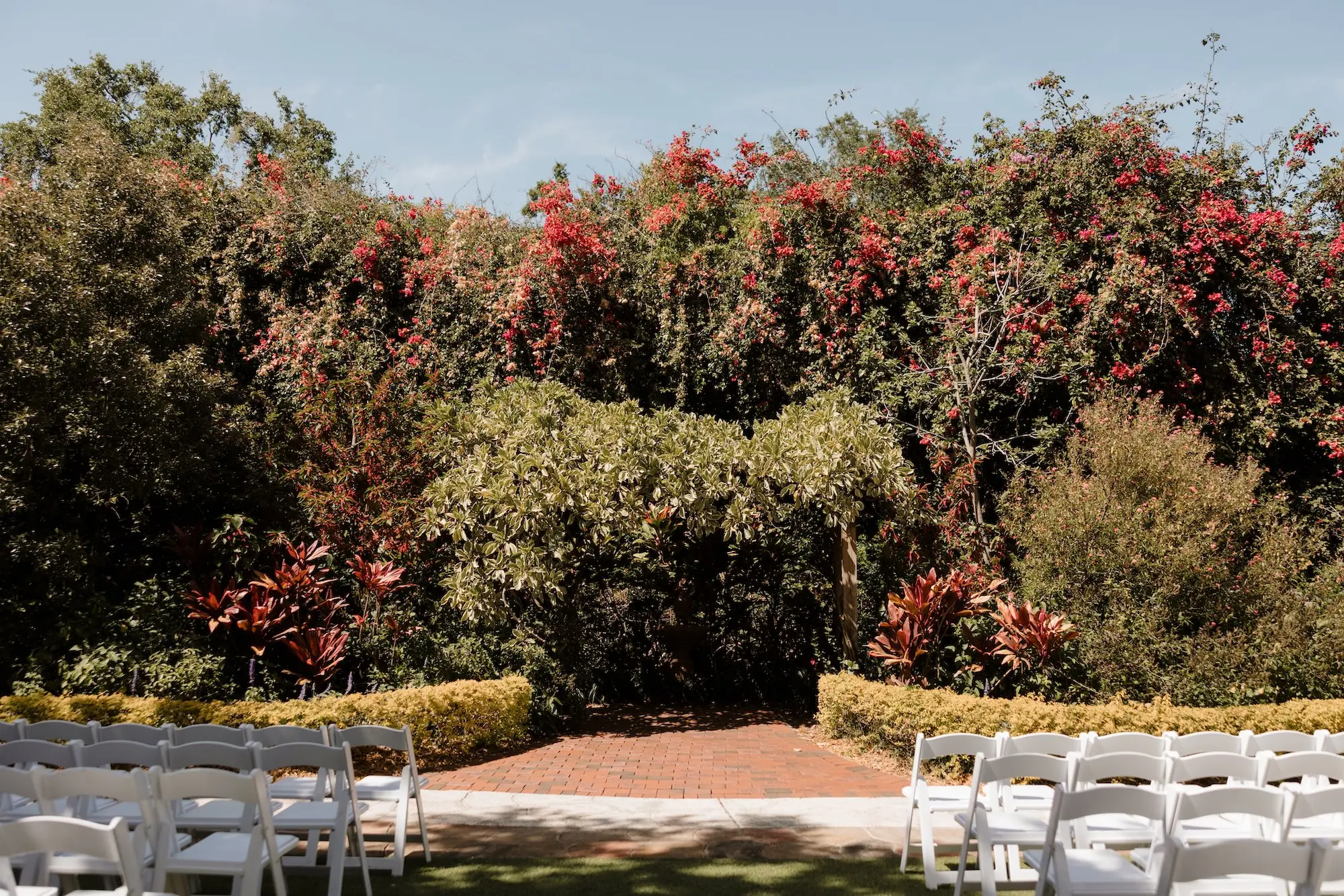 Outdoor St Petersburg Wedding Ceremony Venue Sunken Gardens | White Wedding Ceremony Chairs Inspiration | Ybor Rentals A Chair Affair