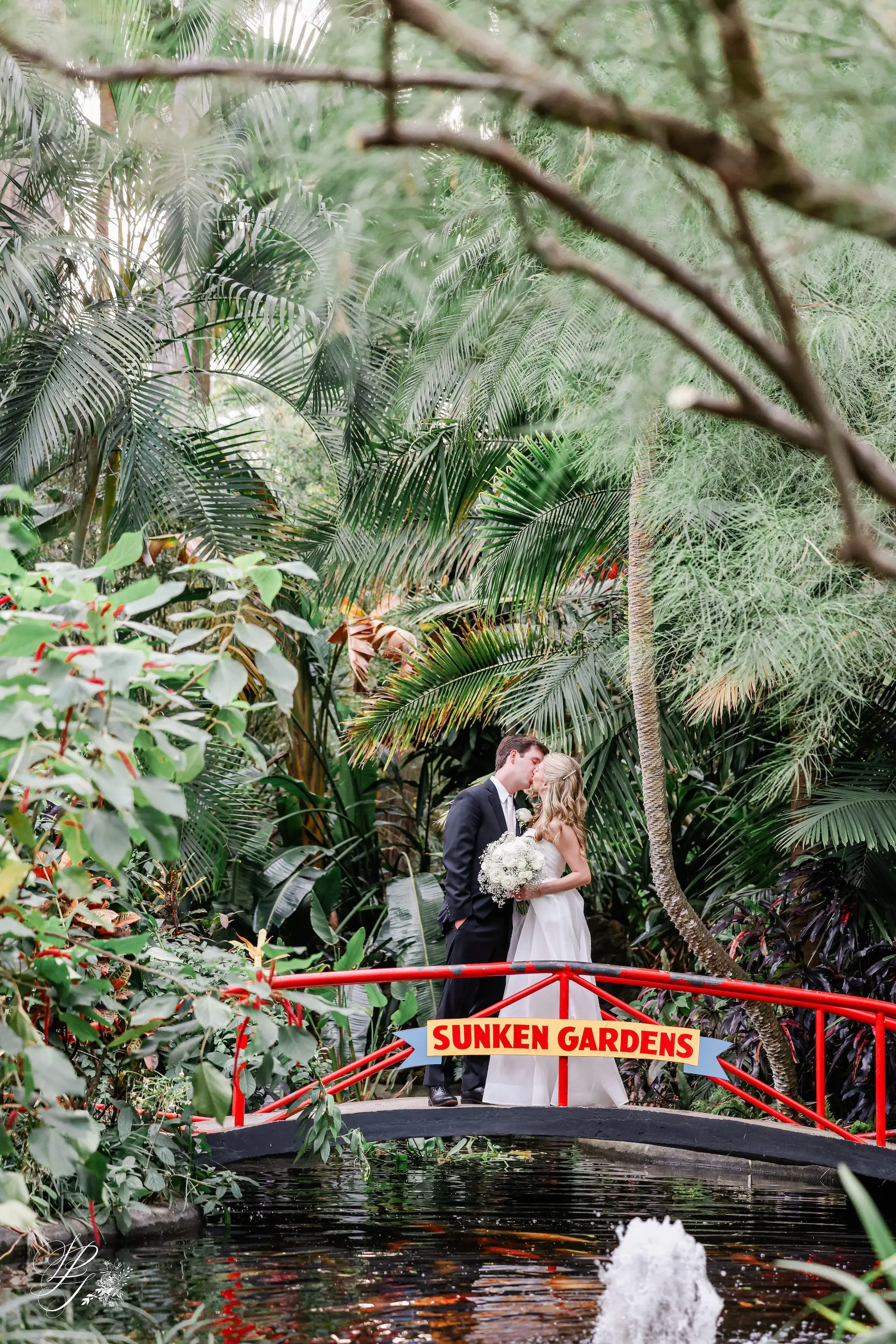 18Elegant Timeless Ivory and Green St Pete Wedding Venue Sunken Gardens - Romantic Outdoor St. Pete Wedding | Sunken Gardens Bride and Groom Kissing on Bridge at St Pete Venue Sunken Gardens Wedding Portrait | St Pete Photographer Lifelong Photography Studio