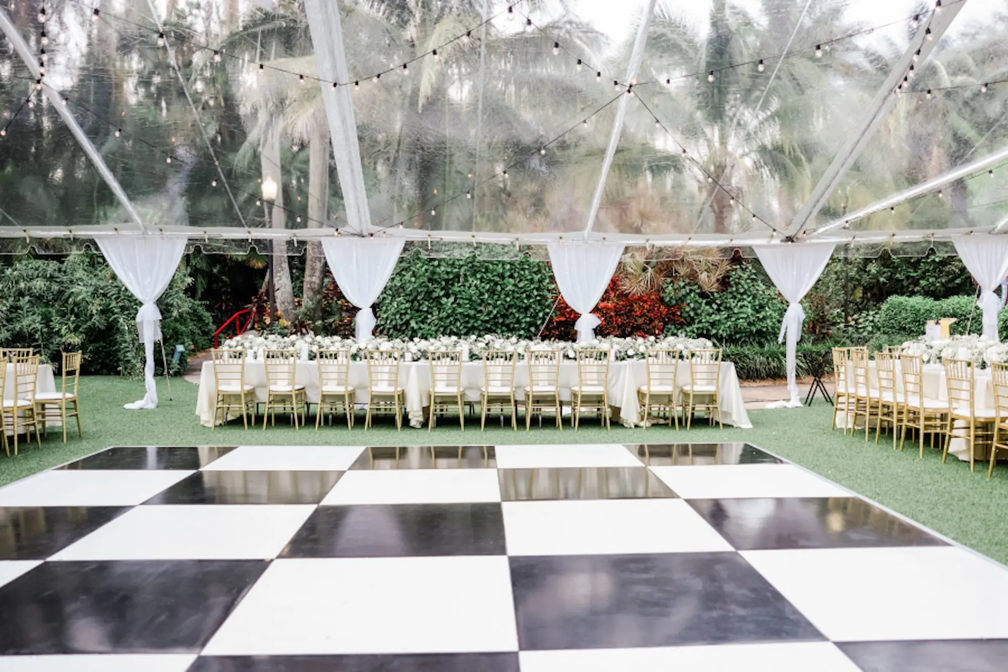 23Elegant Timeless Ivory and Green St Pete Wedding Venue Sunken Gardens - “Best Of” 2025: Wedding Receptions Part 2 Black and White Checkered Dance Floor Wedding Reception Decor Ideas | Outdoor Tented Wedding Reception with String Lights Decor Inspiration | Tampa Bay Rentals Fiesta Solutions Event Rentals | Venue Sunken Gardens