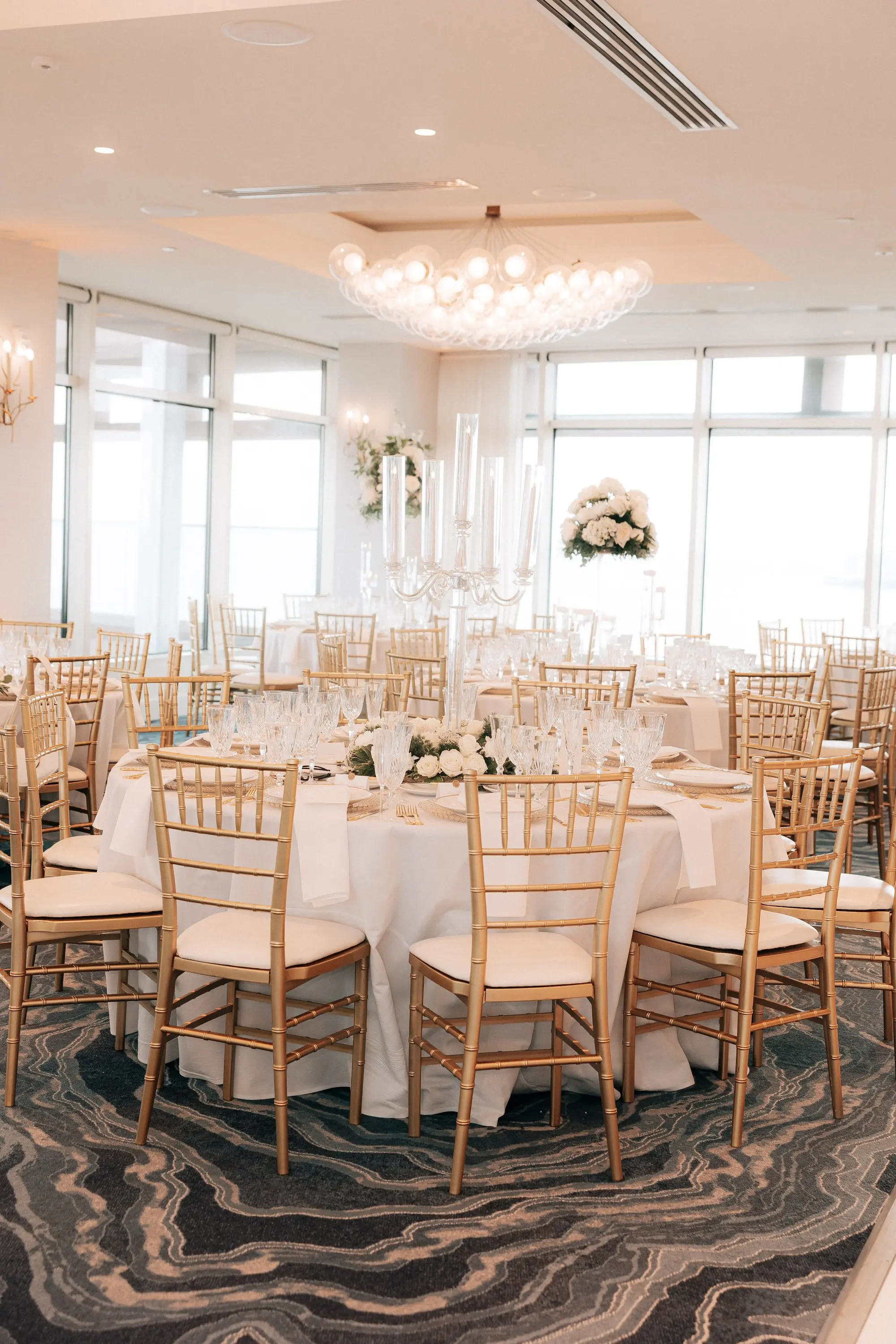 24Classic Gold and White Wedding Decor Inspiration - Classic, Ivory Rooftop Wedding | Grand Hyatt Tampa Bay Classic Gold and White Ballroom Wedding Reception Portrait | Gold Chiavari Chairs at Round White Linen Tables with Tall Monochromatic White Rose Centerpieces Decor Inspiration | Wedding Venue Grand Hyatt Tampa Bay