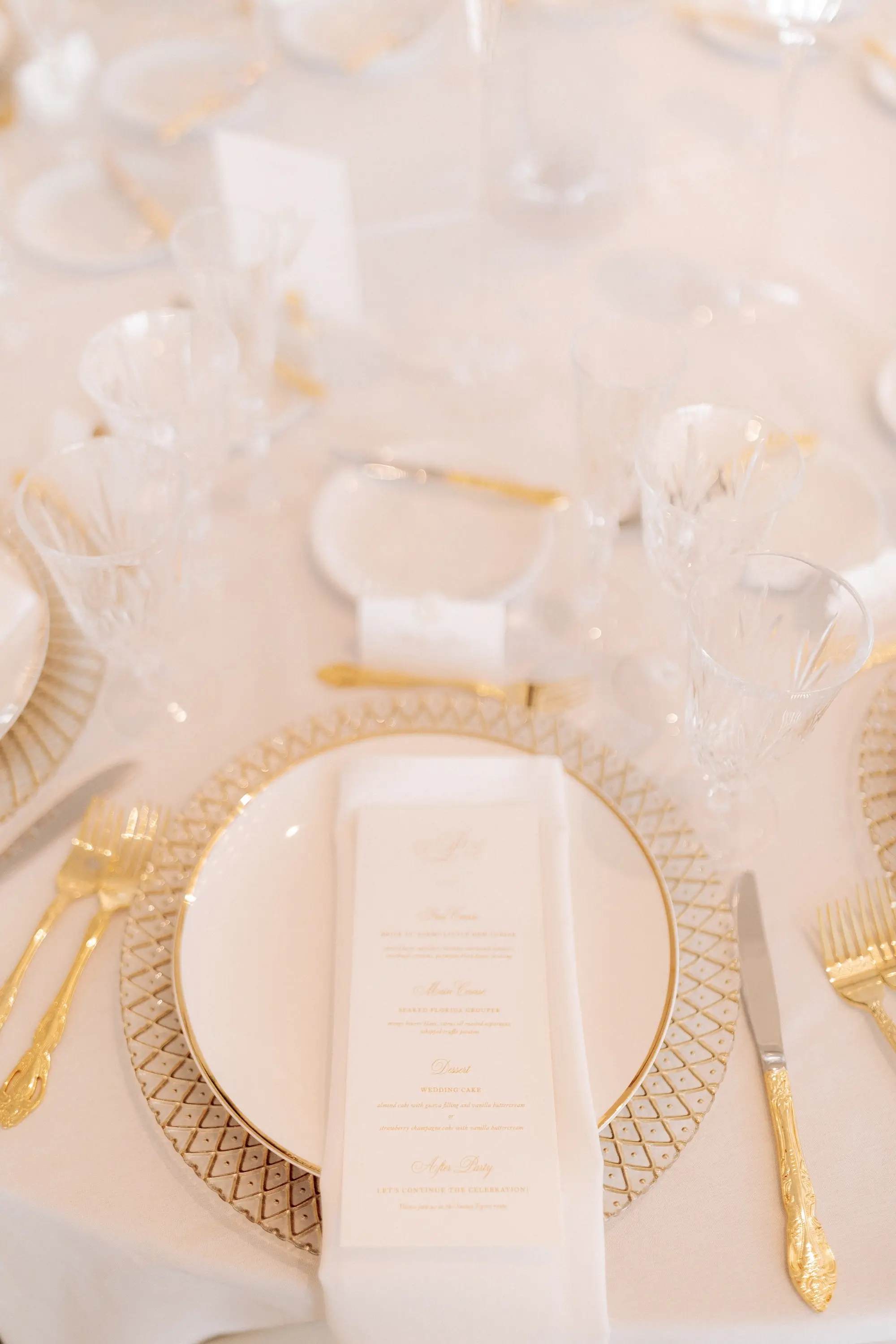 26Classic Gold and White Wedding Decor Inspiration - Classic, Ivory Rooftop Wedding | Grand Hyatt Tampa Bay Elegant Classic White and Gold Wedding Reception Tablescape Decor Inspiration | White Linens with Gold-Patterned Charger and White Dinner Plate with Gold Rim Decor Ideas | White Menu and Napkin with Gold Flatware and Crystal Glassware Inspiration | Sophisticated Clean Aesthetic Wedding Decor Ideas | Florida Rentals Kate Ryan Event Rentals | Tampa Bay Rentals Fiesta Solutions Event Rentals
