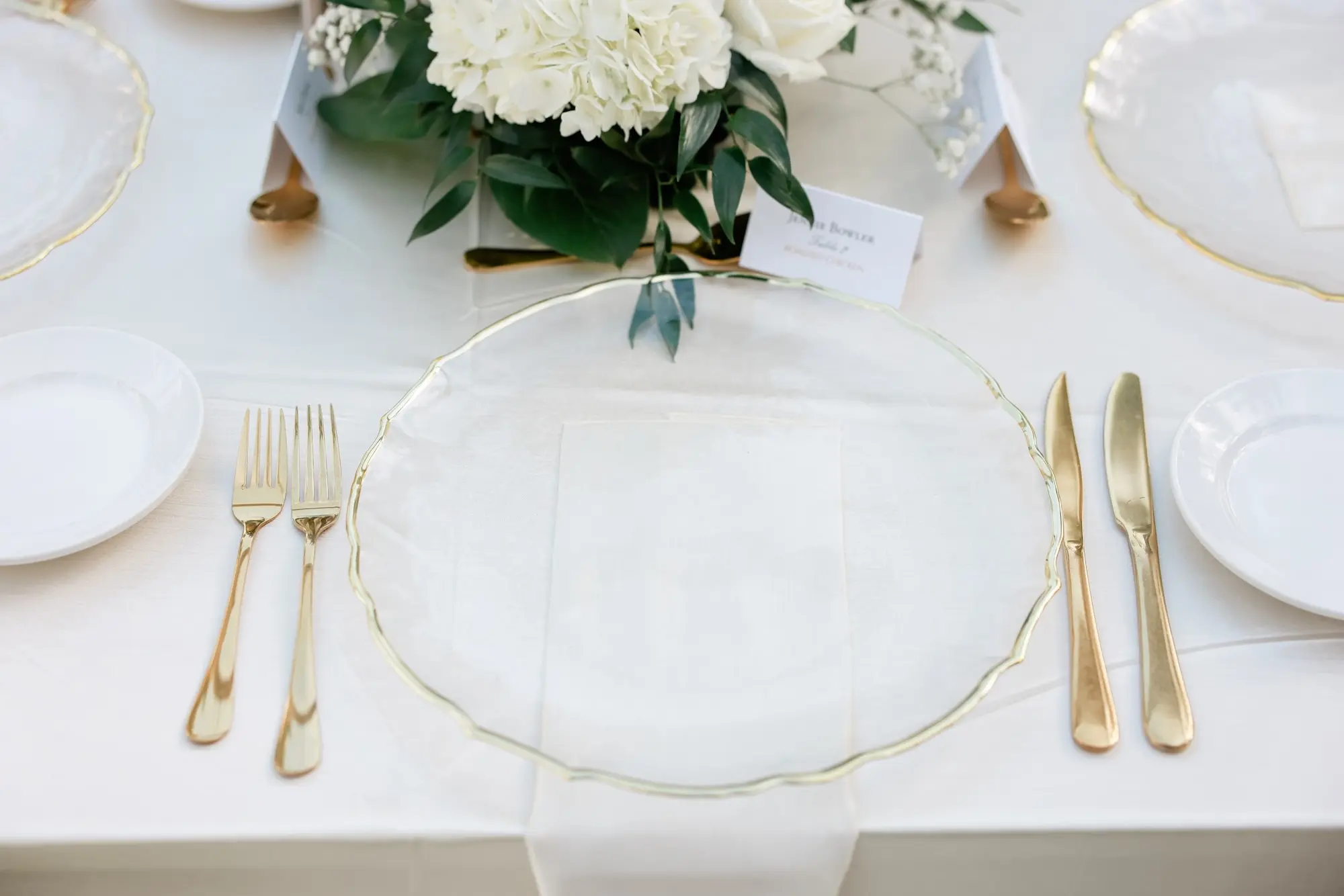 26Elegant Timeless Ivory and Green Garden Wedding - “Best Of” 2025: Wedding Receptions Part 2 Wedding Reception Table with White Linens and Clear Chargers with Gold Rims, Clear Napkins and Gold Flatware Ideas | Tampa Bay Rentals Fiesta Solutions Event Rentals | Caterer Amici's Catered Cuisine