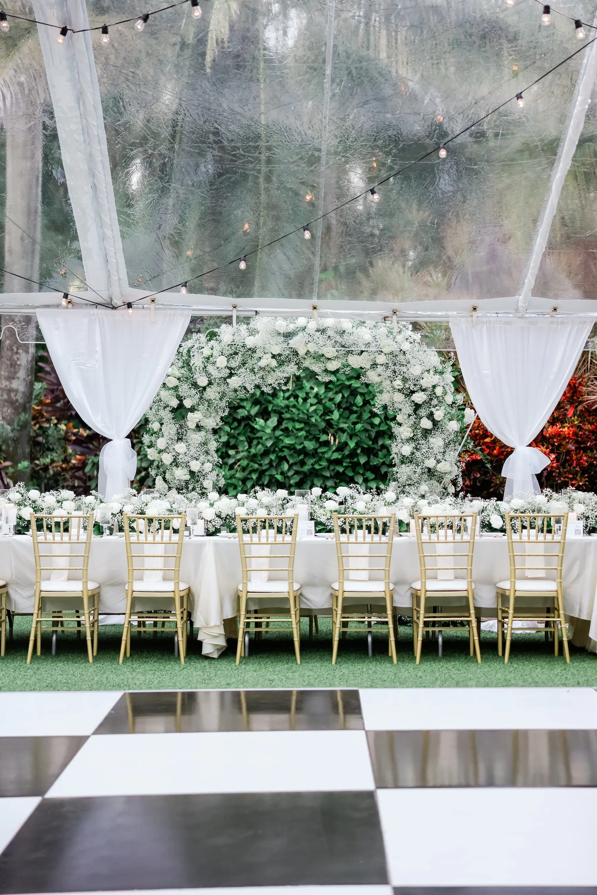 32Elegant Timeless Ivory and Green St Pete Wedding Venue Sunken Gardens - Romantic Outdoor St. Pete Wedding | Sunken Gardens Black and White Checkered Dance Floor Wedding Reception Decor Ideas | Outdoor Tented Wedding Reception with String Lights Decor Inspiration | Gold Chiavari Chairs at Long White Linen Reception Tables Ideas | Tampa Bay Rentals Fiesta Solutions Event Rentals