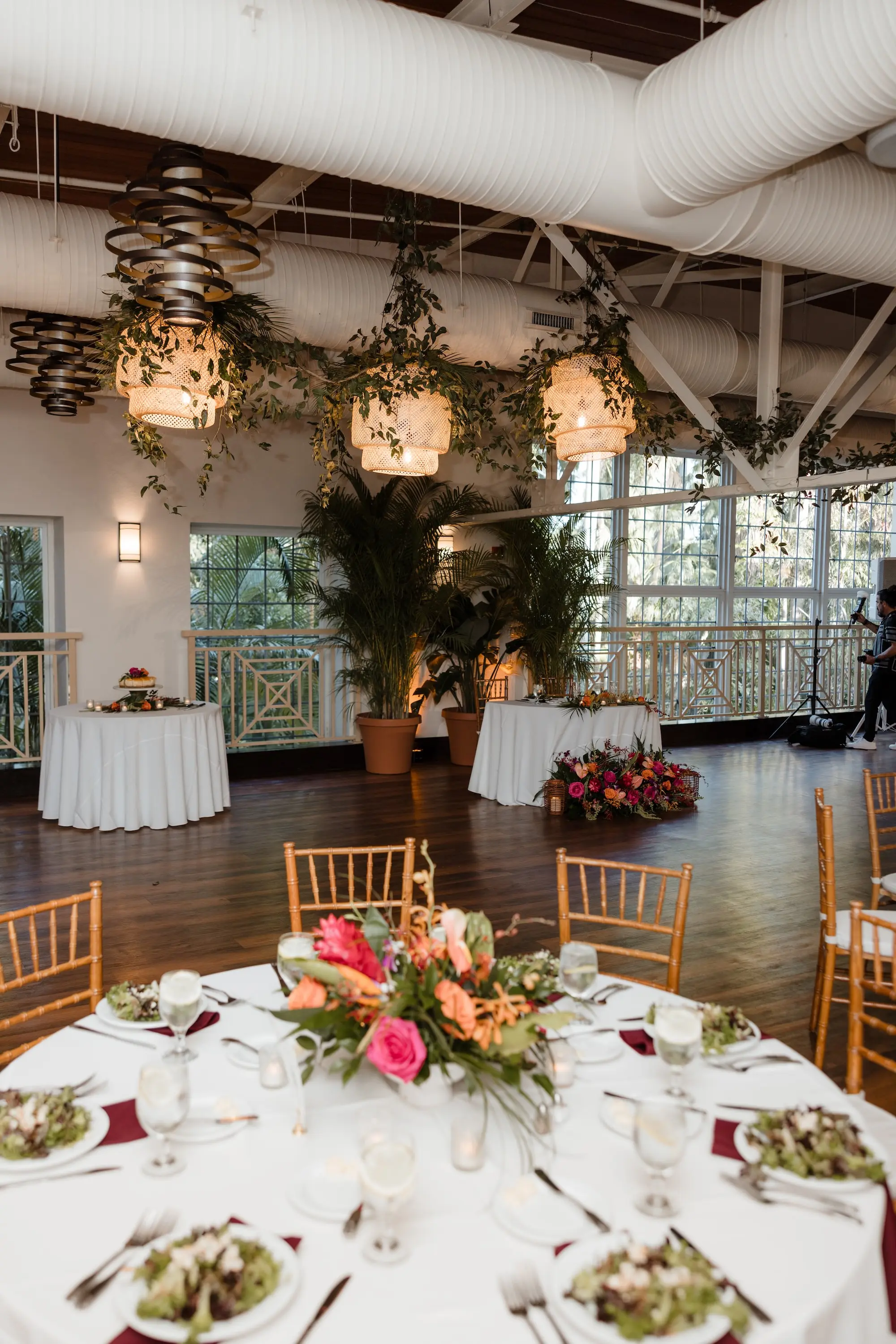 Elegant Tropical Jewel Toned Ballroom Wedding Reception | Garden Bamboo Wooden Chairs | Tall Ferns and Hanging Greenery Garland Wedding Reception Decor Ideas | Lush Pink, Orange, Red, Yellow Birds of Paradise, Red Ginger, Monsteras Palm Greenery Flower Arrangement Centerpiece Inspiration | Tampa Bay Florist Save The Date Florida | Venue Sunken Gardens | Tampa Bay Caterer Amicis Catered Cuisine