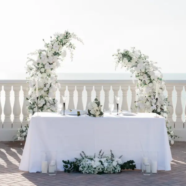 Romantic White Rose and Florals in Greenery Semi Circle Arches Wedding Reception Sweetheart Table Backdrop Decor Inspiration | White Florals and Greenery Flower Arrangement Decor Ideas | Waterfront Wedding Venue Hyatt Regency Clearwater Beach