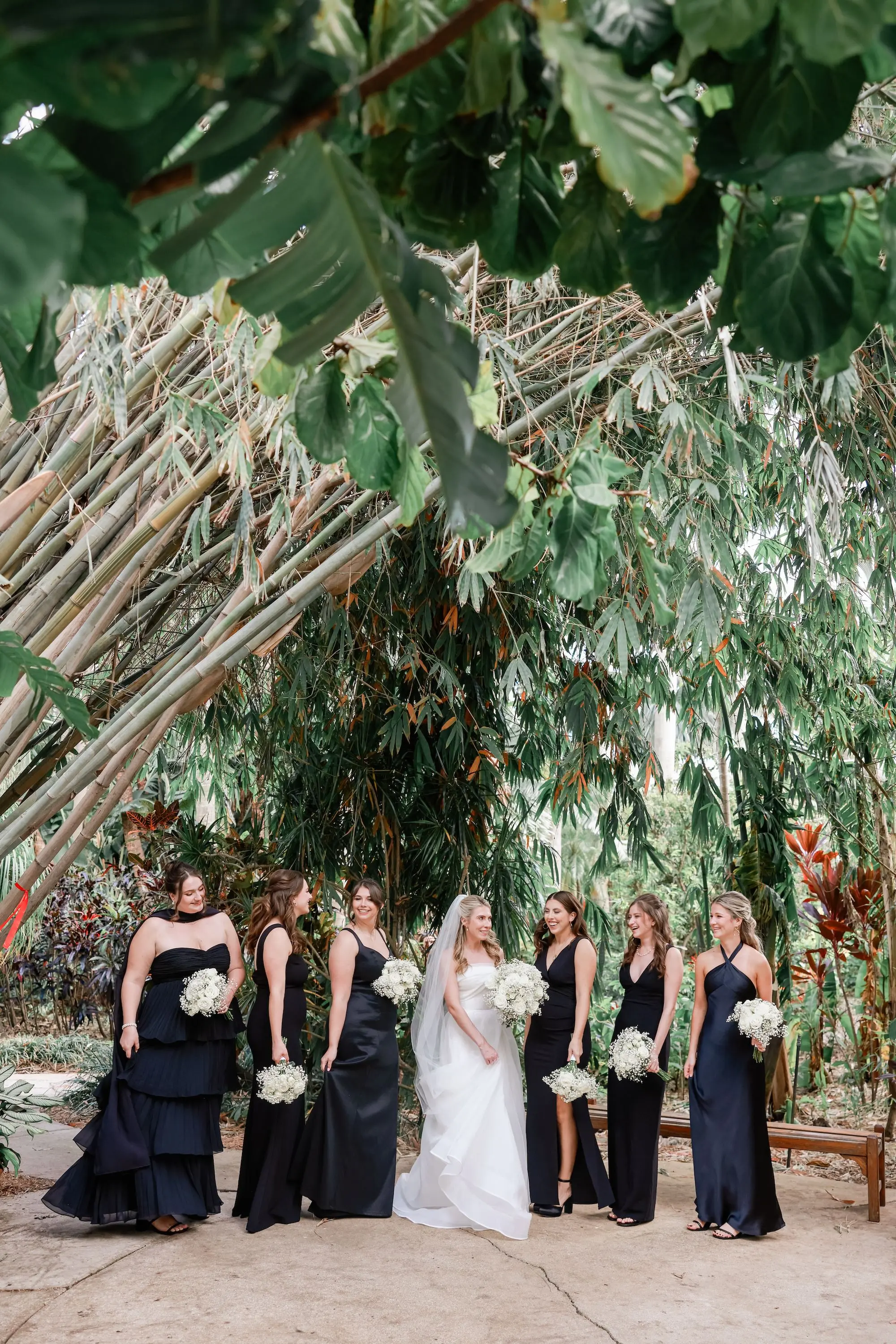 3Elegant Timeless Ivory and Green St Pete Wedding Venue Sunken Gardens - Romantic Outdoor St. Pete Wedding | Sunken Gardens Bride and Bridesmaid Outdoor St Pete Venue Sunken Gardens Wedding Portrait | Mismatched Style Black Bridesmaid Dresses Inspiration | Classic White Roses and Baby's Breath Bouquet Ideas | St Pete Photographer Lifelong Photography Studio | Sarasota Hair and Makeup Artist Femme Akoi Beauty Studio