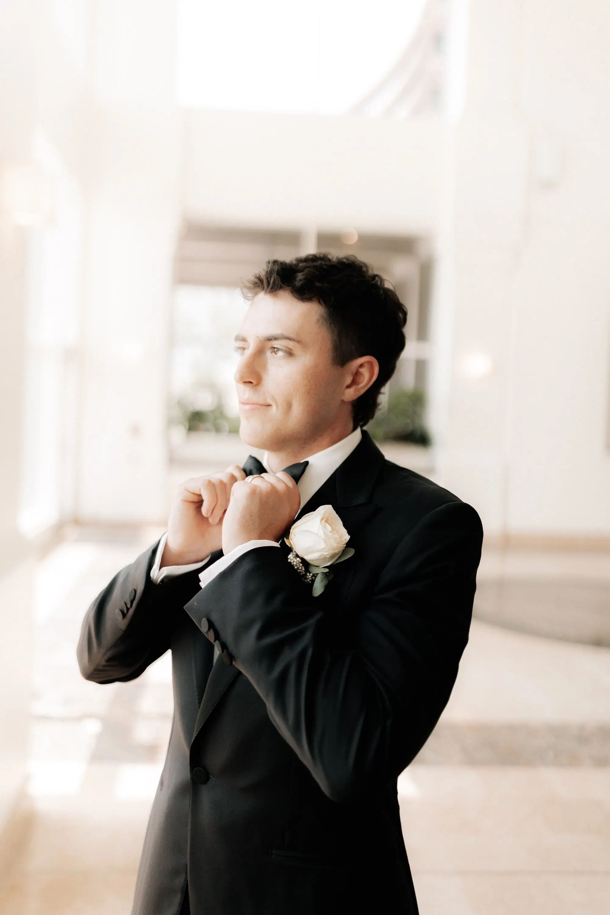 4Classic Gold and White Wedding Decor Inspiration - Classic, Ivory Rooftop Wedding | Grand Hyatt Tampa Bay Groom Getting Ready Wedding Portrait | Classic Black and White Tuxedo Groom Attire Ideas | White Rose Boutonniere Ideas