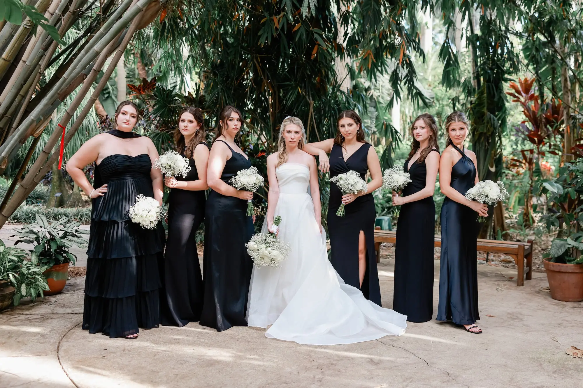 4Elegant Timeless Ivory and Green Garden Wedding - Romantic Outdoor St. Pete Wedding | Sunken Gardens Bride and Bridesmaid Outdoor St Pete Venue Sunken Gardens Wedding Portrait | Mismatched Style Black Bridesmaid Dresses Inspiration | Classic White Roses and Baby's Breath Bouquet Ideas | St Pete Photographer Lifelong Photography Studio | Sarasota Hair and Makeup Artist Femme Akoi Beauty Studio
