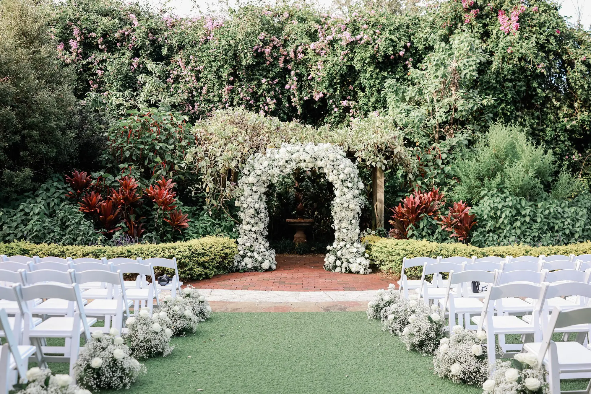 5Elegant Timeless Ivory and Green St Pete Wedding Venue Sunken Gardens - Romantic Outdoor St. Pete Wedding | Sunken Gardens Outdoor Garden Wedding Ceremony Inspiration | White Roses with Baby's Breath Altar Arch Decor Inspiration | White Wedding Ceremony Chairs with White Roses and Baby's Breath Flower Arrangement Aisle Decor Ideas | St Pete Venue Sunken Gardens