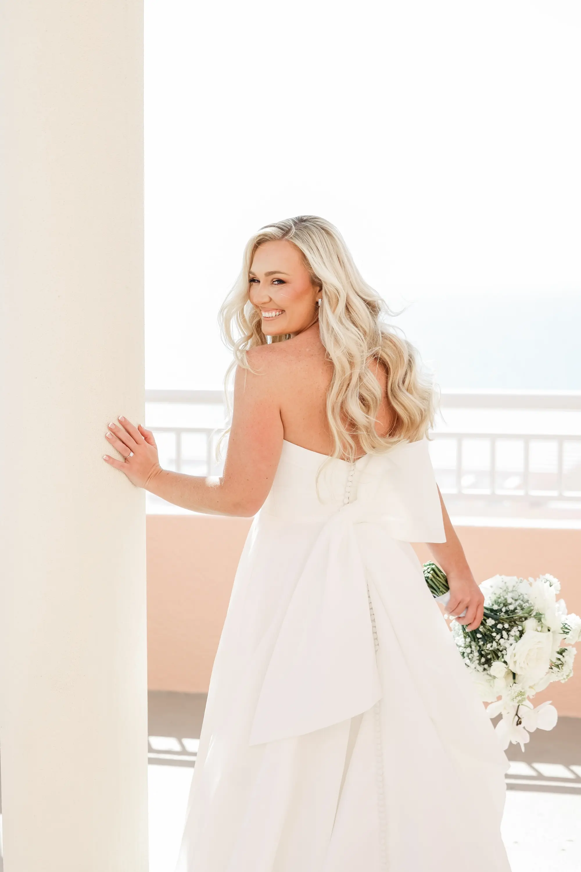 12Classic White Florida Wedding Ideas - Classic, White Rooftop Wedding | Hyatt Regency Clearwater Beach Bride Balcony Wedding Portrait | White Kelly Faetanini Modern A-Line Strapless Wedding Gown with Back Bow Accent Inspiration | Tampa Bay Photographer Lifelong Photography Studio