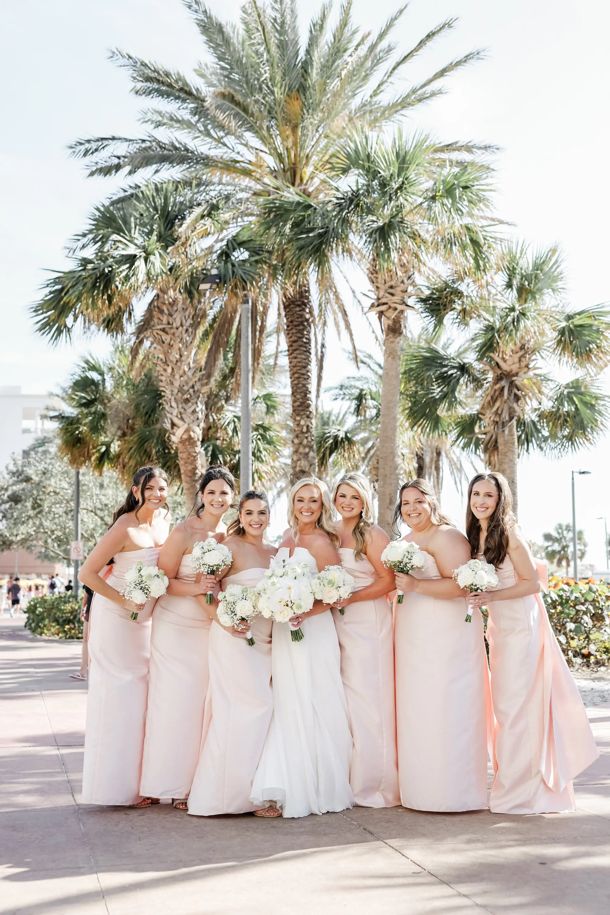 21Classic White Florida Wedding Ideas - Classic, White Rooftop Wedding | Hyatt Regency Clearwater Beach Bride and Bridesmaids Wedding Portrait | Light Pink Strapless Bridesmaid Dresses with Back Bow Inspiration | Monochromatic White Rose Bridal Bouquet Ideas | Tampa Bay Photographer Lifelong Photography Studio