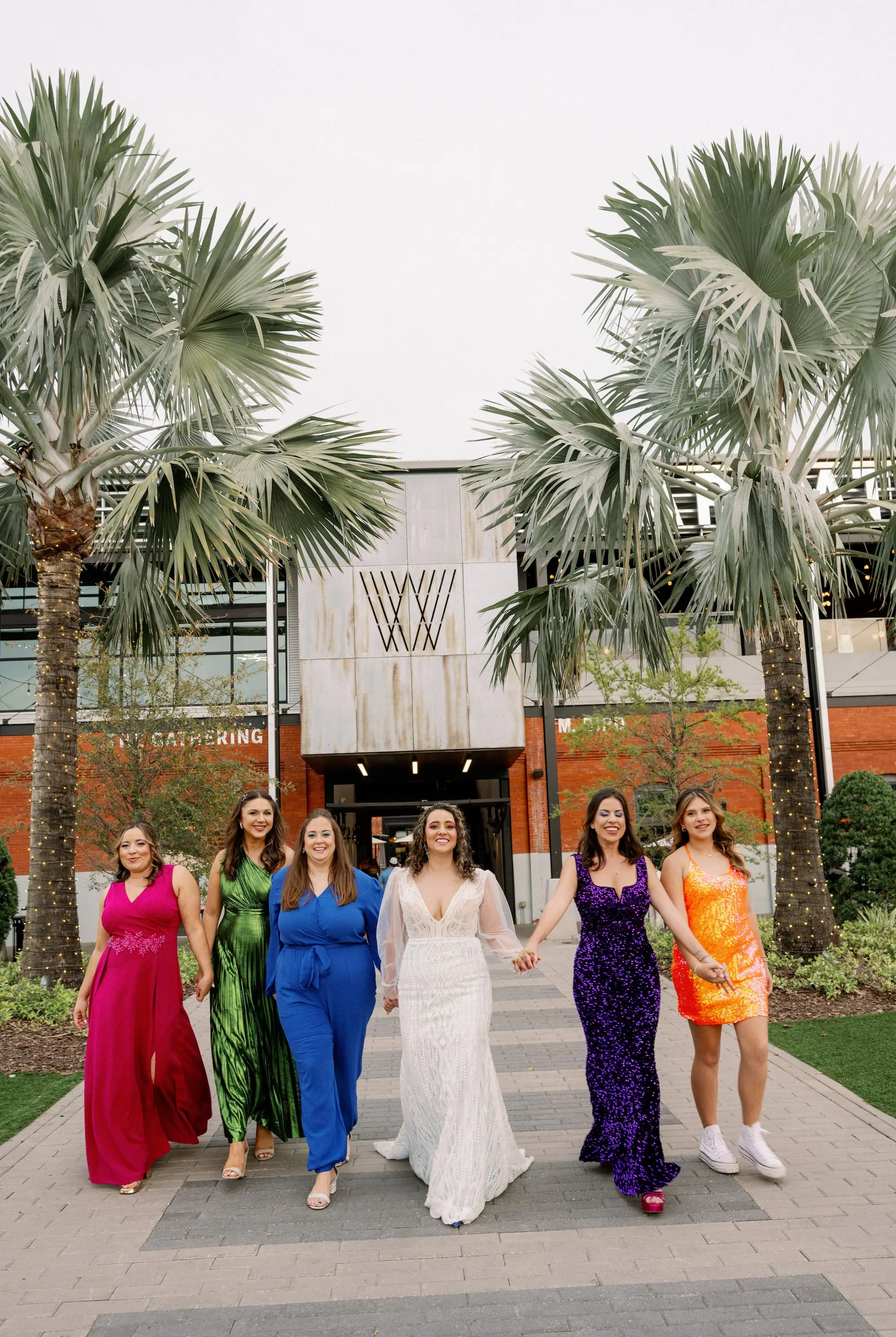 24Whimsical Rainbow Inspired Wedding Ideas - Whimsical, Vibrant Downtown Tampa Wedding | Armature Works Bride with Bridesmaids Wedding Portrait | Different Style Rainbow Pink, Green, Blue, Purple, Orange Bridesmaid Attire Inspiration | Tampa Bay Photographer Dewitt For Love Photography