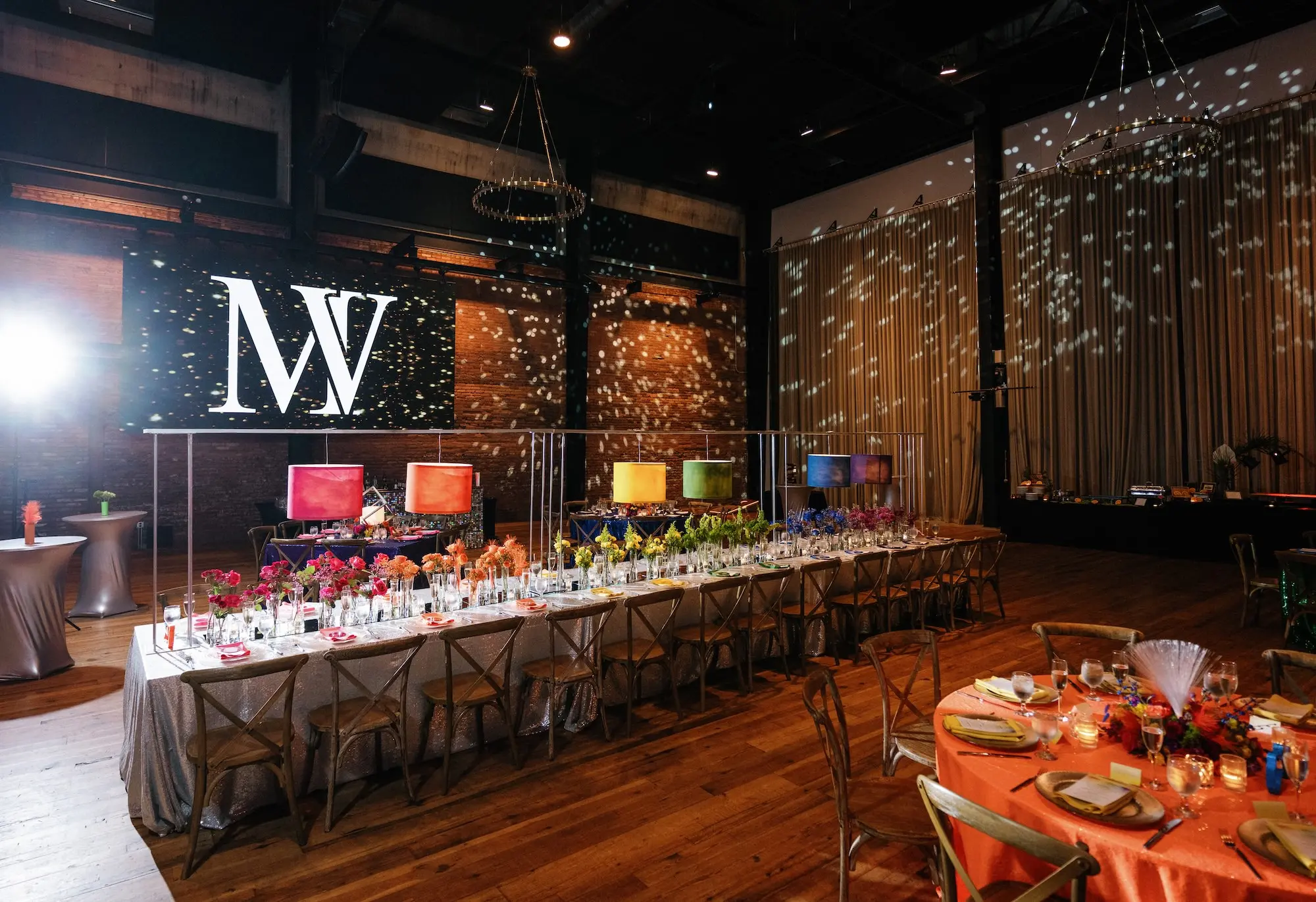 25Whimsical Rainbow Inspired Wedding Ideas Tampa Venue Armature Works - “Best Of” 2025: Wedding Receptions Part 2 Bright Colorful Rainbow Wedding Reception Long Table Decor Inspiration | Silver Sequined Table Cloth Ideas | Red, Orange, Yellow, Green, Blue, Indigo, Violet Flower Centerpiece Bud Vase Arrangement Decor Inspiration | Bold Rainbow Lighting Lamp Table Decor Ideas | Tabletop Rentals A Chair Affair | Over The Top Rental Linens | Event Planner Unique Weddings and Events | Industrial Tampa Wedding Venue Armature Works