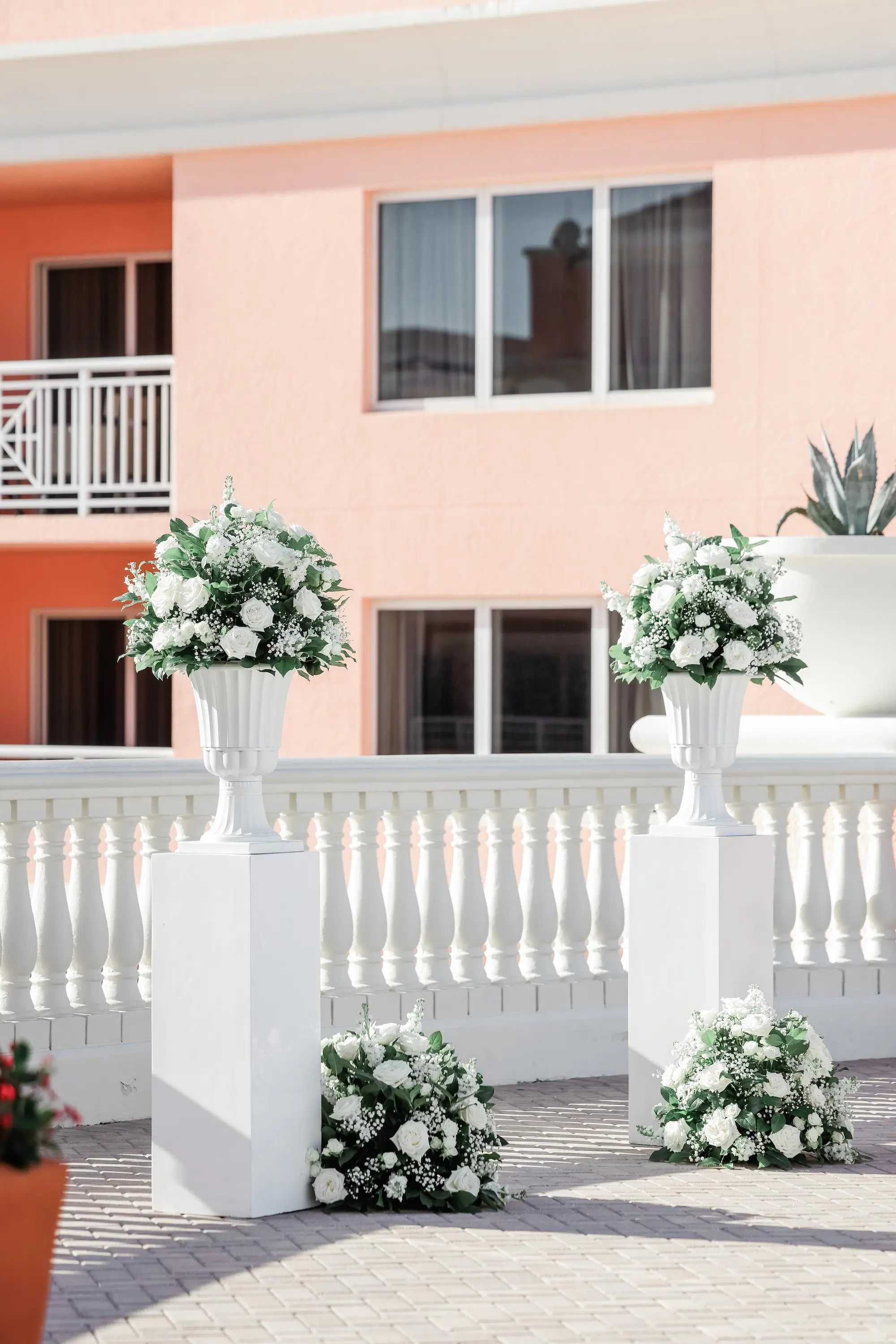 26Classic White Florida Wedding Ideas - Classic, White Rooftop Wedding | Hyatt Regency Clearwater Beach Monochromatic White Roses and Baby's Breath Flower Arrangement on White Columns Wedding Ceremony Decor Ideas | Tampa Bay Planner Planner Coastal Coordinating | Florida Wedding Venue Hyatt Regency Clearwater Beach Resort and Spa