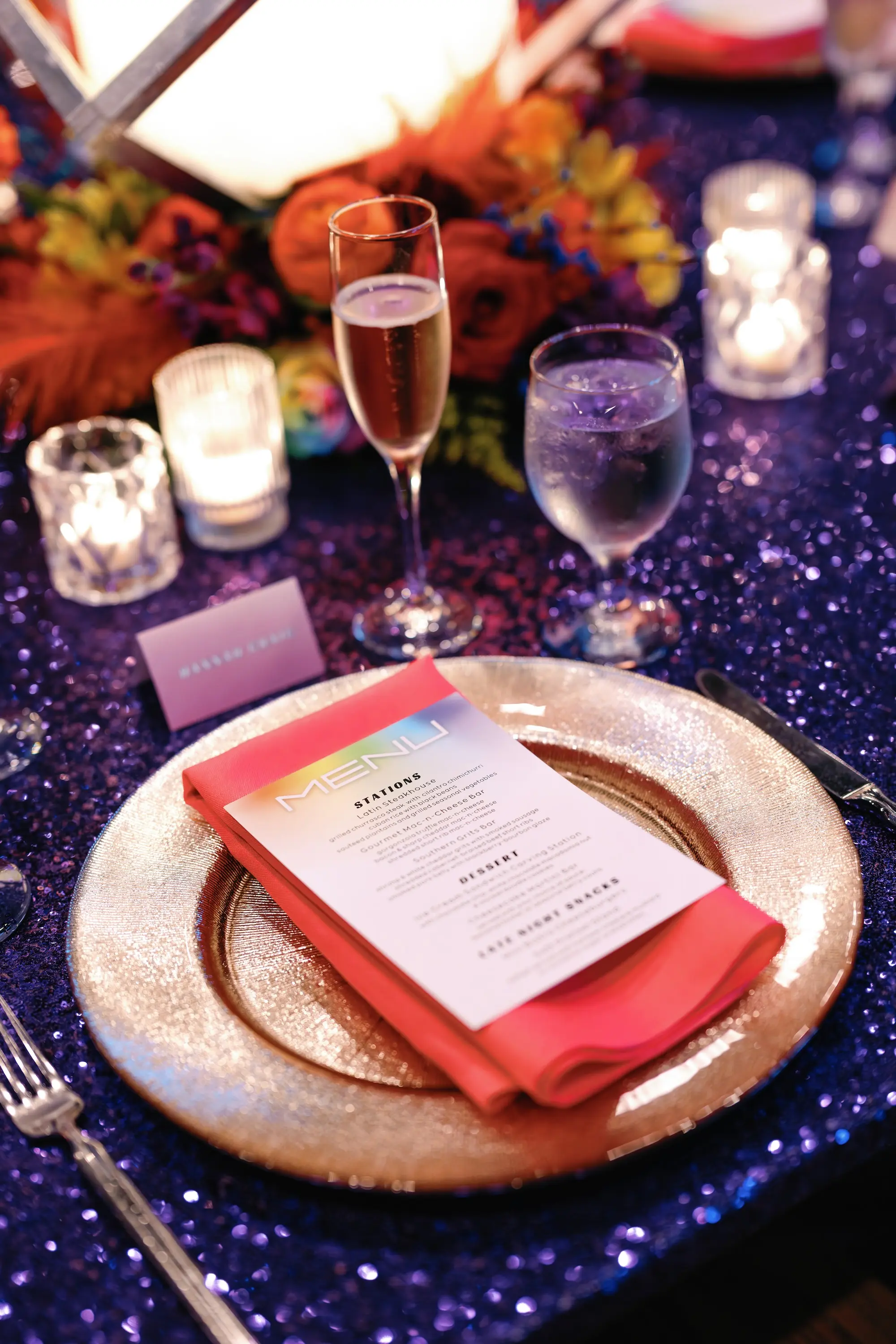 29Whimsical Rainbow Inspired Wedding Ideas - “Best Of” 2025: Wedding Receptions Part 2 Bright Colorful Rainbow Wedding Reception Decor Inspiration | Blue Sequined Table Cloth with Clear Charger and Rainbow Menu, Red Napkin Tablescape Ideas | Tabletop Rentals A Chair Affair | Over The Top Rental Linens | Event Planner Unique Weddings and Events