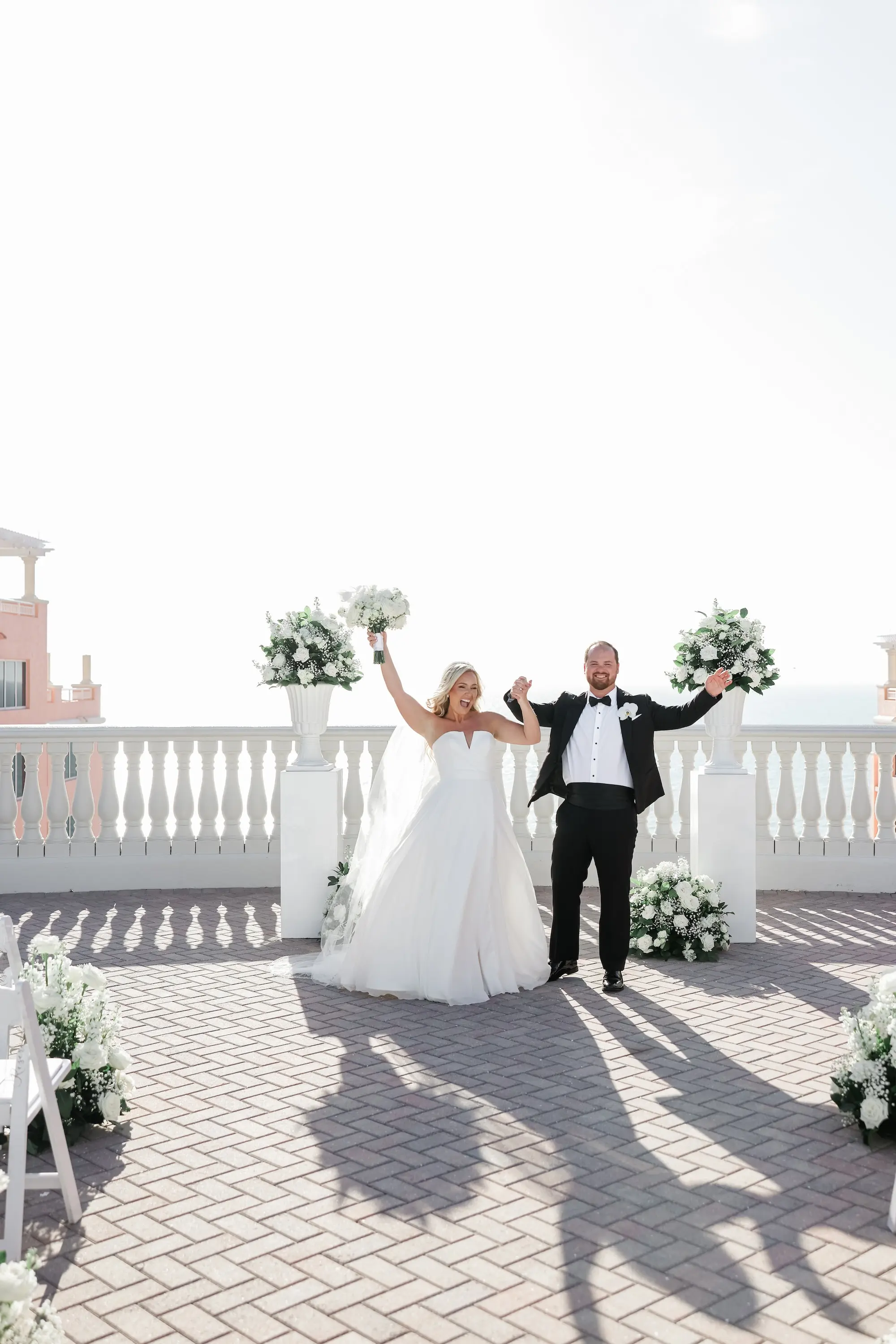 35Classic White Florida Wedding Ideas - Classic, White Rooftop Wedding | Hyatt Regency Clearwater Beach Bride and Groom Wedding Ceremony Balcony Oceanview Just Married Portrait | Monochromatic White Roses and Baby's Breath Flower Arrangement on White Columns Ceremony Decor Ideas | Tampa Bay Photographer Lifelong Photography Studio | Florida Wedding Venue Hyatt Regency Clearwater Beach Resort and Spa