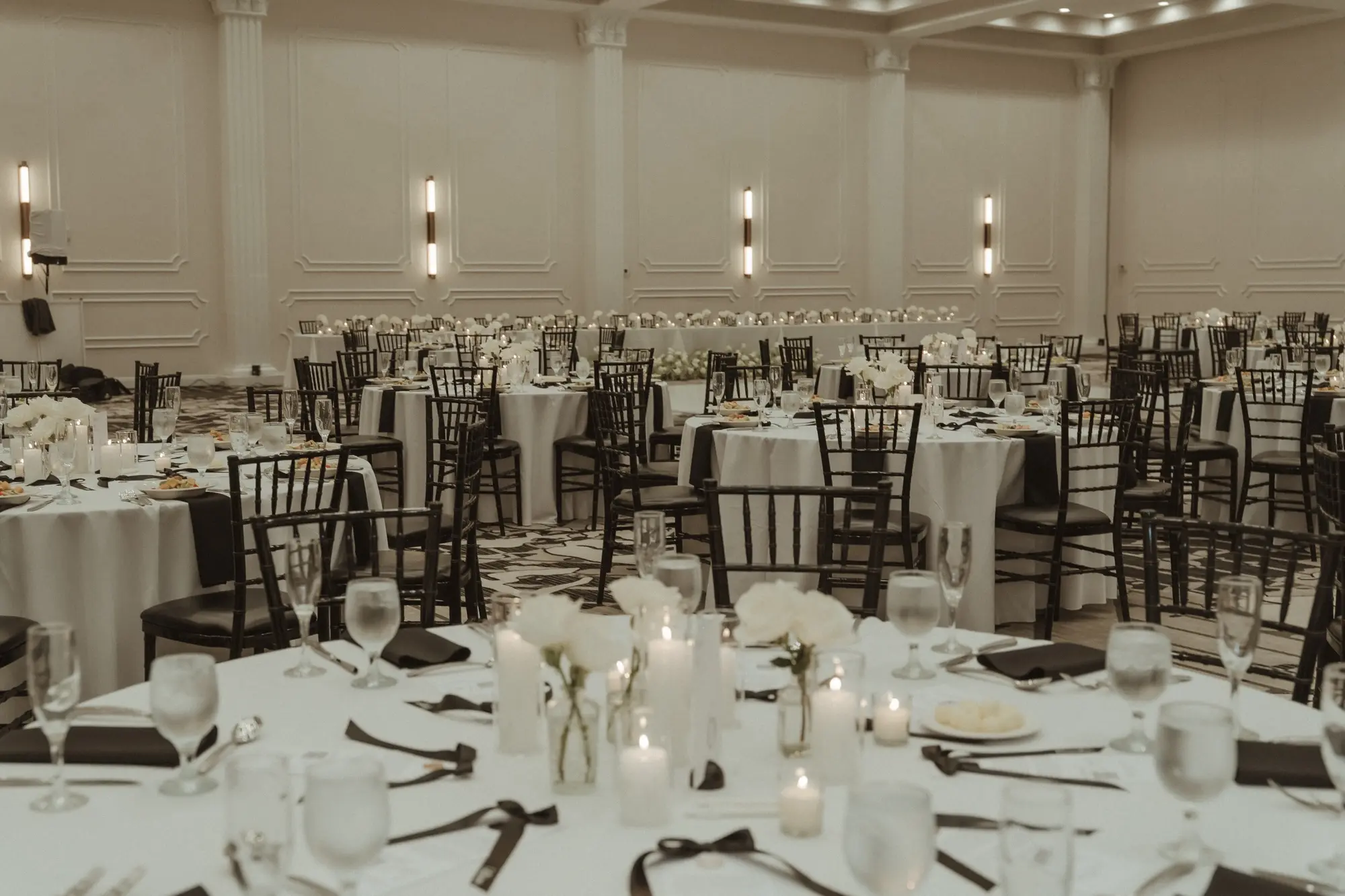 37Sophiscated Black and White Wedding Inspiration Tampa Venue Hotel Flor - “Best Of” 2025: Wedding Receptions Part 2 Timeless Black and White Wedding Reception Decor Ideas | White Table Linens with Black Napkins and Black Chiavari Chairs Wedding Reception Decor Inspiration | Romantic Candles and Single Stem White Roses in Bud Vases Centerpiece Decor Ideas | Historic Tampa Venue Hotel Flor | Tampa Bay Planner The Olive Tree Weddings