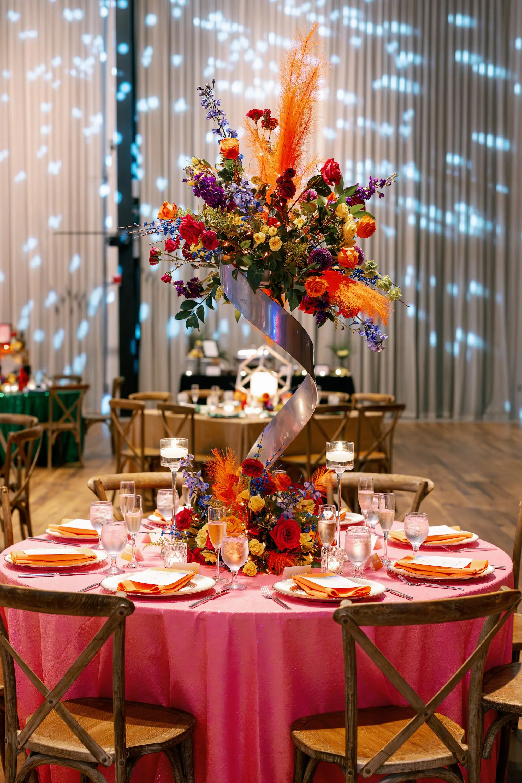 37Whimsical Rainbow Inspired Wedding Ideas - “Best Of” 2025: Wedding Receptions Part 2 Bright Colorful Rainbow Wedding Reception Sweetheart Table Decor Inspiration | Bright Pink Table Cloth Ideas | Red, Orange, Yellow, Green, Blue, Indigo, Violet Flower Arrangement Reception Decor Inspiration | Over The Top Rental Linens | Event Planner Unique Weddings and Events | Tabletop Rentals A Chair Affair