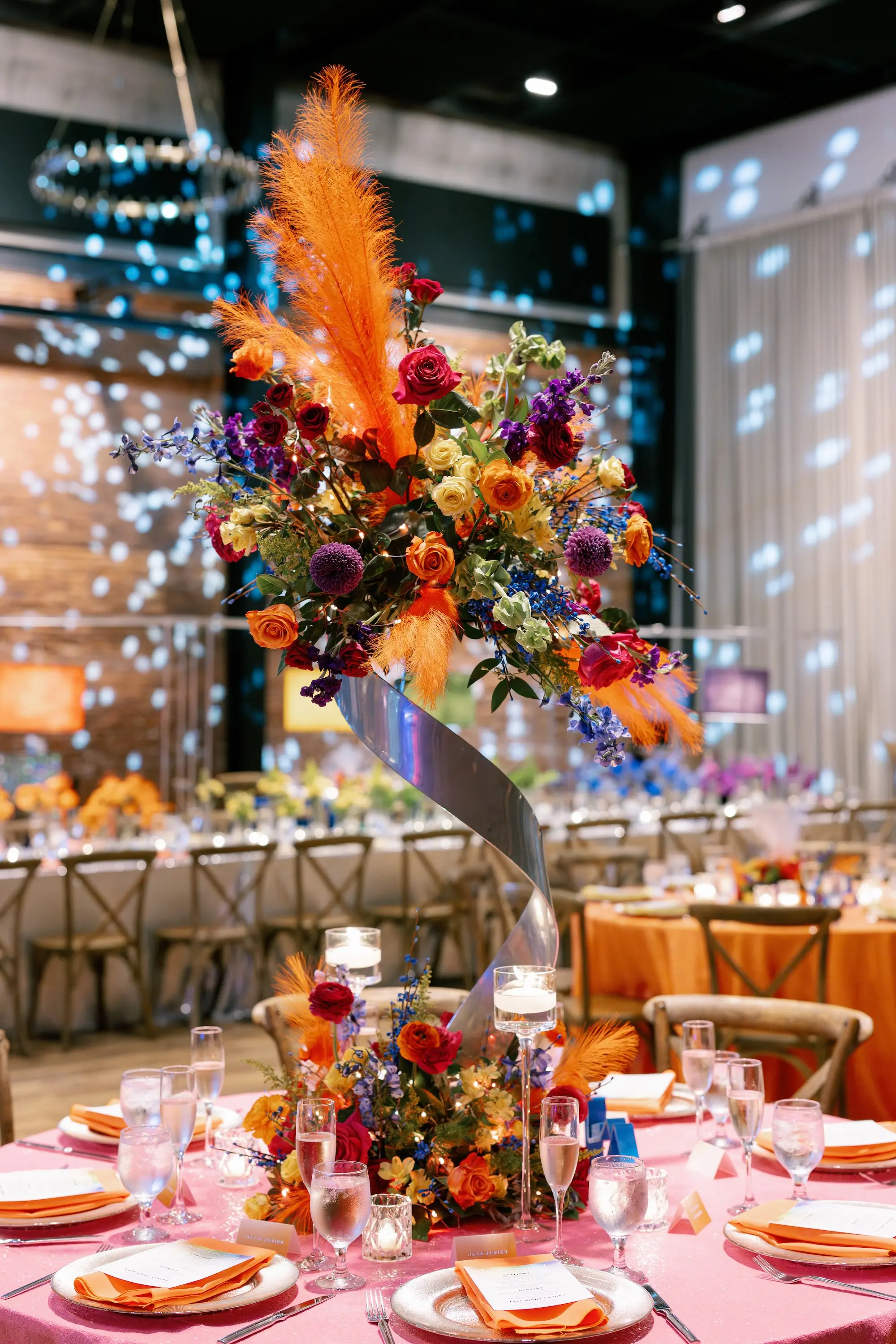 40Whimsical Rainbow Inspired Wedding Ideas - “Best Of” 2025: Wedding Receptions Part 2 Bright Colorful Rainbow Wedding Reception Sweetheart Table Decor Inspiration | Bright Pink Table Cloth Ideas | Red, Orange, Yellow, Green, Blue, Indigo, Violet Flower Arrangement Reception Decor Inspiration | Over The Top Rental Linens | Event Planner Unique Weddings and Events | Tabletop Rentals A Chair Affair