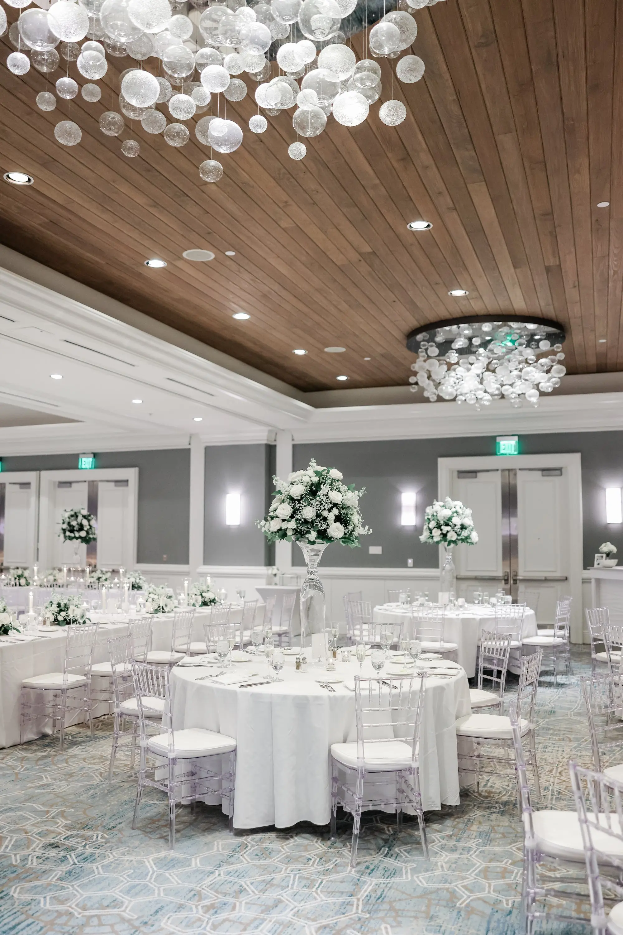 43 1Classic White Florida Wedding Ideas Venue Hyatt Clearwater Beach - Classic, White Rooftop Wedding | Hyatt Regency Clearwater Beach Luxurious Monochromatic White Ballroom Wedding Reception | Modern Clear Chiavari Chairs | Tall Glass Centerpieces with White, Roses and Greenery Flower Arrangement Ideas | Tampa Bay Planner Planner Coastal Coordinating | St Pete Rentals Gabro Event Services | Wedding Venue Hyatt Regency Clearwater Beach Resort and Spa