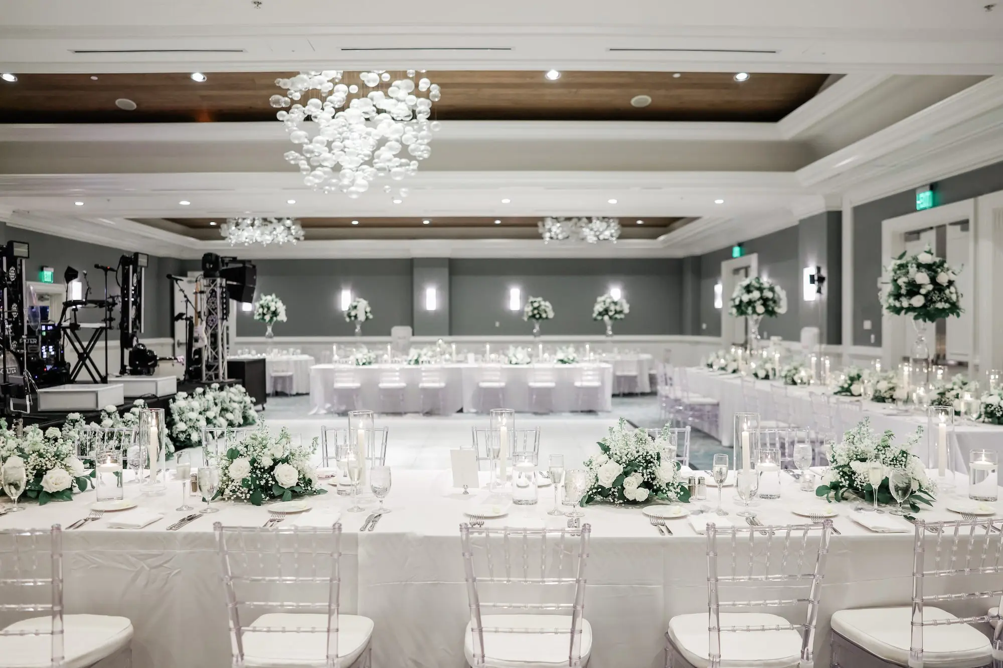 44Classic White Florida Wedding Ideas Venue Hyatt Clearwater Beach - Classic, White Rooftop Wedding | Hyatt Regency Clearwater Beach Luxurious Monochromatic White Ballroom Wedding Reception | Modern Clear Chiavari Chairs | Tall Glass Centerpieces with White, Roses and Greenery Flower Arrangement Ideas | Tampa Bay Planner Planner Coastal Coordinating | St Pete Rentals Gabro Event Services | Wedding Venue Hyatt Regency Clearwater Beach Resort and Spa