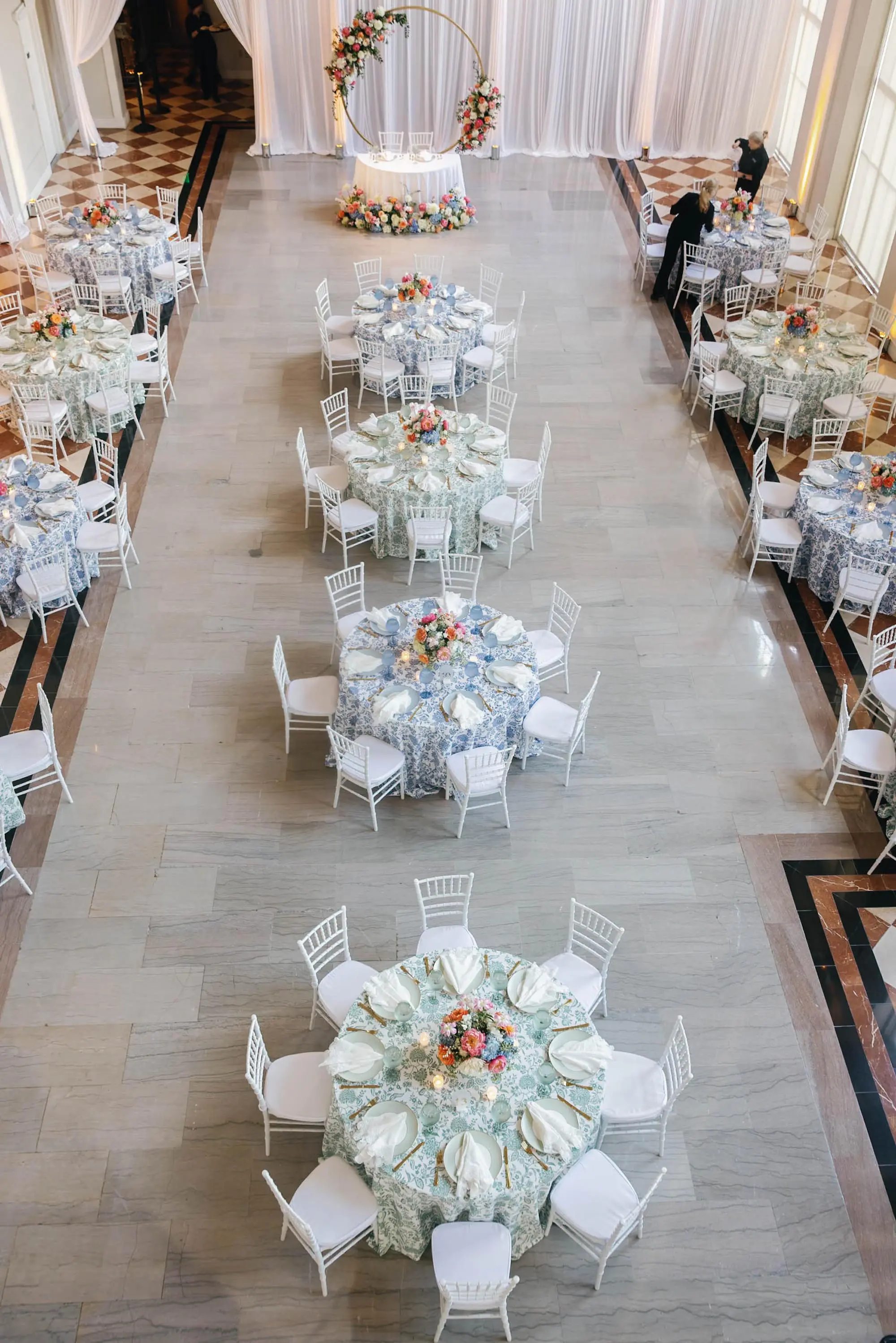 44European Inspired Blue and Green Wedding Inspiration Tampa Venue The Vault - “Best Of” 2025: Wedding Receptions Part 2 European Inspired Wedding Reception Decor Ideas | Floral Detailed Green and Blue Tablecloths Ideas | White Chiavari Wedding Reception Chairs Inspiration | Historic Chateau Inspired Wedding Venue The Vault | Florist Monarch Events and Design | Kate Ryan Event Rentals