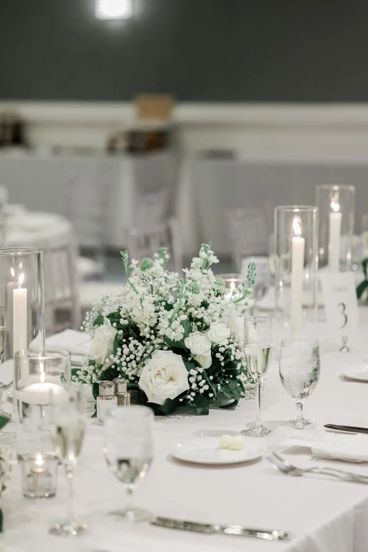 45Classic White Florida Wedding Ideas - Classic, White Rooftop Wedding | Hyatt Regency Clearwater Beach White Linens with Romantic White Taper Candles Wedding Reception Tablescape Decor Ideas | White Roses and Greenery Flower Arrangement Decor Inspiration | Tampa Bay Planner Planner Coastal Coordinating | St Pete Rentals Gabro Event Services | Wedding Venue Hyatt Regency Clearwater Beach Resort and Spa