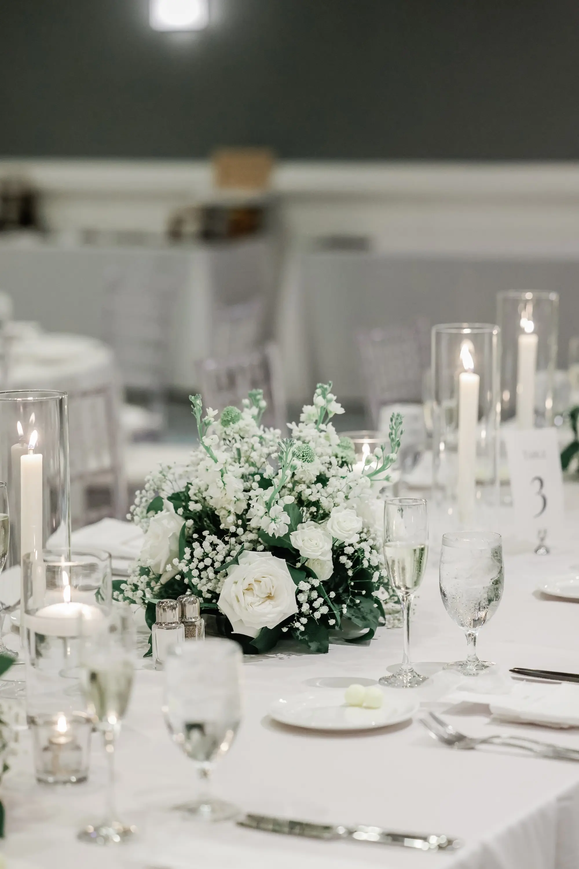 45Classic White Florida Wedding Ideas - Classic, White Rooftop Wedding | Hyatt Regency Clearwater Beach White Linens with Romantic White Taper Candles Wedding Reception Tablescape Decor Ideas | White Roses and Greenery Flower Arrangement Decor Inspiration | Tampa Bay Planner Planner Coastal Coordinating | St Pete Rentals Gabro Event Services | Wedding Venue Hyatt Regency Clearwater Beach Resort and Spa