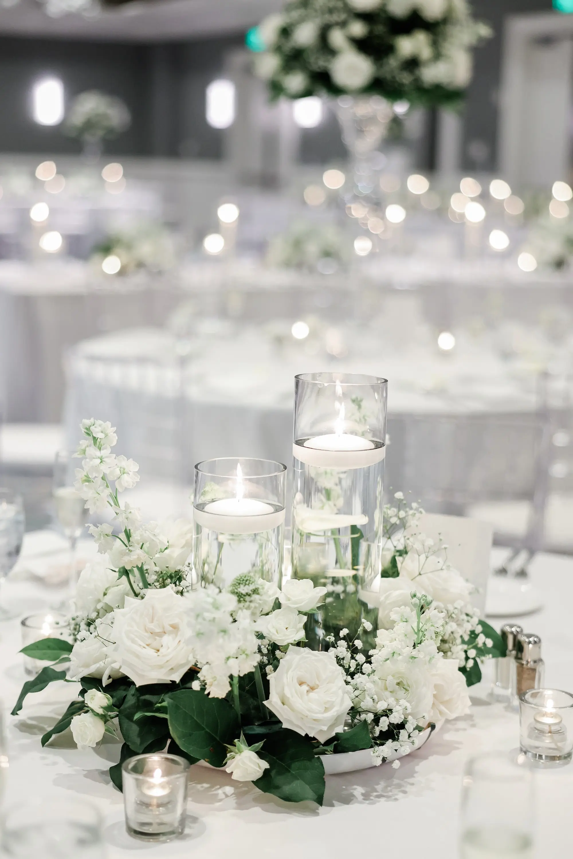 46Classic White Florida Wedding Ideas - Classic, White Rooftop Wedding | Hyatt Regency Clearwater Beach Romantic Floating Candles and White Roses with Greenery Flower Arrangement Wedding Reception Table Decor Inspiration | Tampa Bay Planner Planner Coastal Coordinating | St Pete Rentals Gabro Event Services | Wedding Venue Hyatt Regency Clearwater Beach Resort and Spa