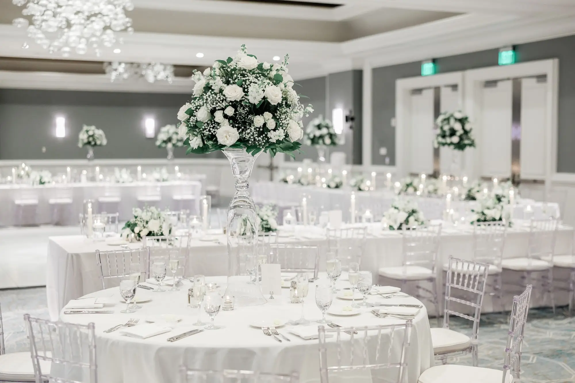 47Classic White Florida Wedding Ideas Venue Hyatt Clearwater Beach - Classic, White Rooftop Wedding | Hyatt Regency Clearwater Beach Luxurious Monochromatic White Ballroom Wedding Reception | Modern Clear Chiavari Chairs | Tall Glass Centerpieces with White, Roses and Greenery Flower Arrangement Ideas | Tampa Bay Planner Planner Coastal Coordinating | St Pete Rentals Gabro Event Services | Wedding Venue Hyatt Regency Clearwater Beach Resort and Spa
