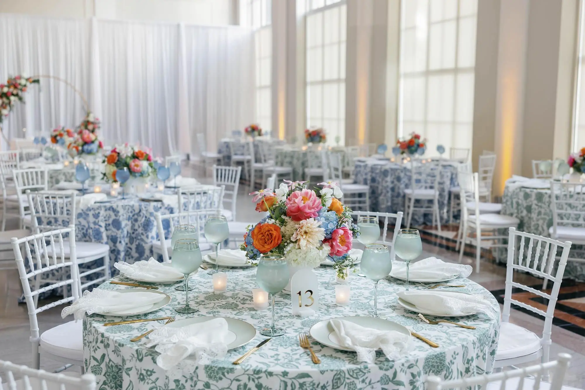 52European Inspired Blue and Green Wedding Inspiration Tampa Venue The Vault - “Best Of” 2025: Wedding Receptions Part 2 European Inspired Wedding Reception Decor Ideas | Floral Detailed Green and Blue Tablecloths Ideas | White Chiavari Wedding Reception Chairs Inspiration | Historic Chateau Inspired Wedding Venue The Vault | Florist Monarch Events and Design | Kate Ryan Event Rentals