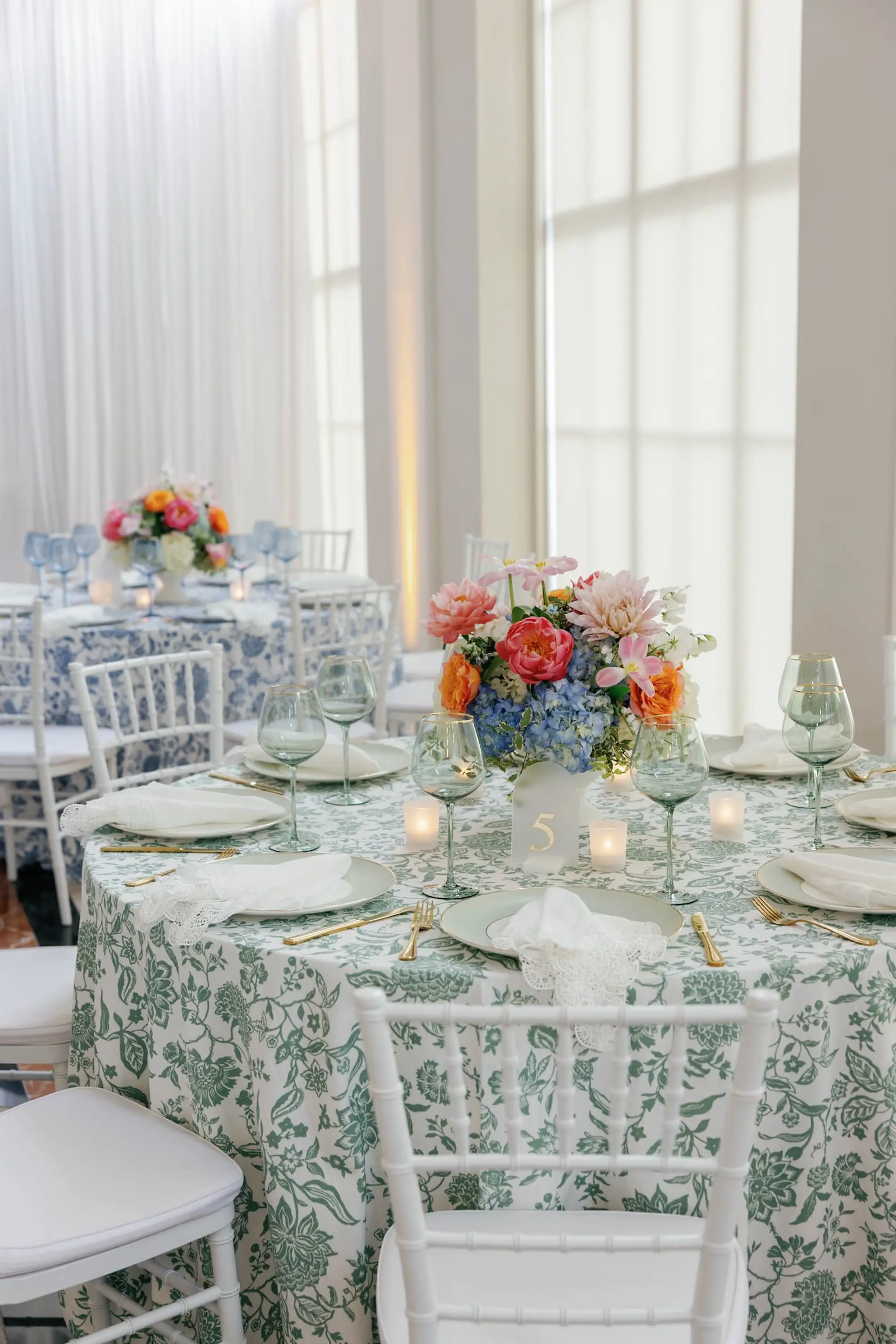 53European Inspired Blue and Green Wedding Inspiration - “Best Of” 2025: Wedding Receptions Part 2 European Inspired Wedding Reception Decor Ideas | Floral Detailed Green and Blue Tablecloths Ideas | White Chiavari Wedding Reception Chairs Inspiration | Historic Chateau Inspired Wedding Venue The Vault | Florist Monarch Events and Design | Kate Ryan Event Rentals