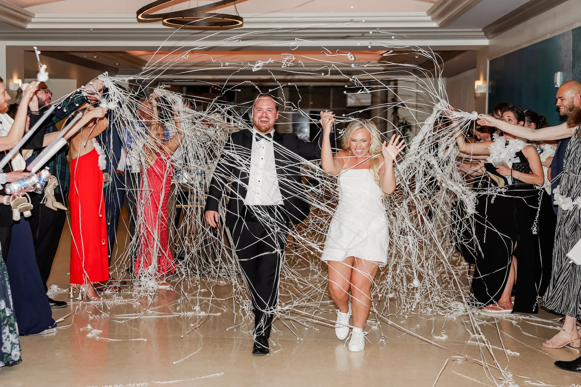 54Classic White Florida Wedding Ideas - Classic, White Rooftop Wedding | Hyatt Regency Clearwater Beach Bride and Groom Streamer Exit Wedding Reception Portrait | Tampa Bay Photographer Lifelong Photography Studio